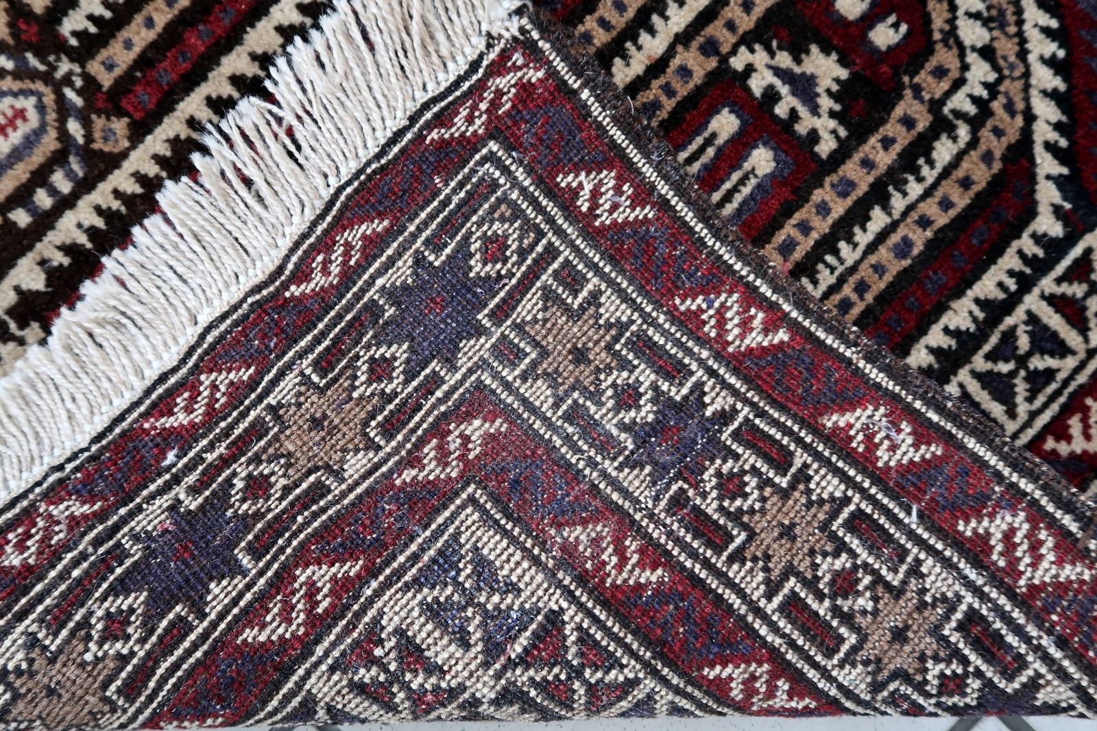 Handmade vintage Afghan Baluch rug in unusual multi-praying design. The rug is from the end of 20th century made in wool.