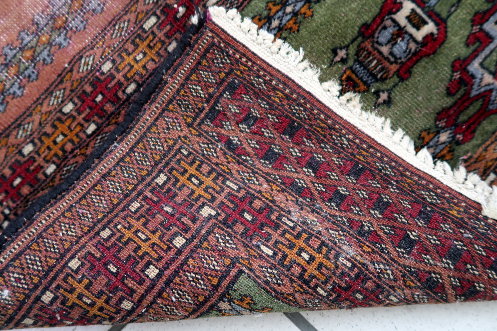 Handmade vintage Uzbek Bukhara rug in prayer design. The rug is from the middle of 20th century made in wool. The rug is in original condition, has some low pile