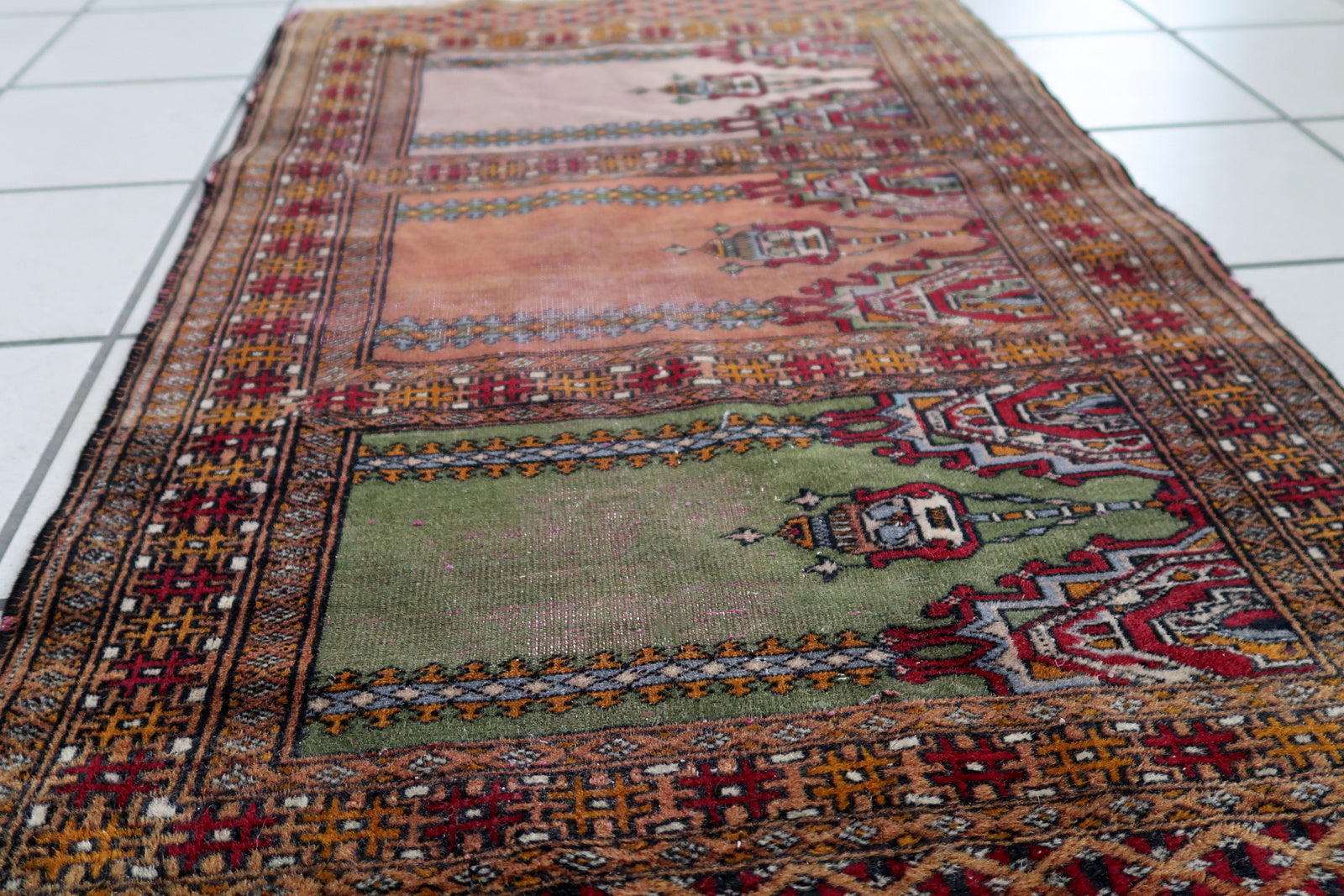 Handmade vintage Uzbek Bukhara rug in prayer design. The rug is from the middle of 20th century made in wool. The rug is in original condition, has some low pile