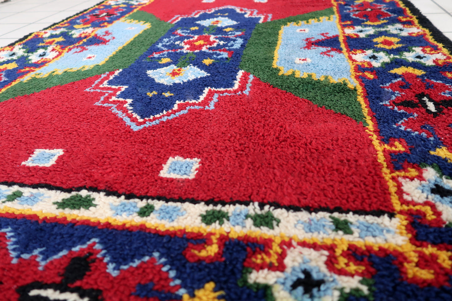 Vintage French Savonnerie rug in colorful shades. The rug has been made in wool in the middle of 20th century. It is in original good condition.