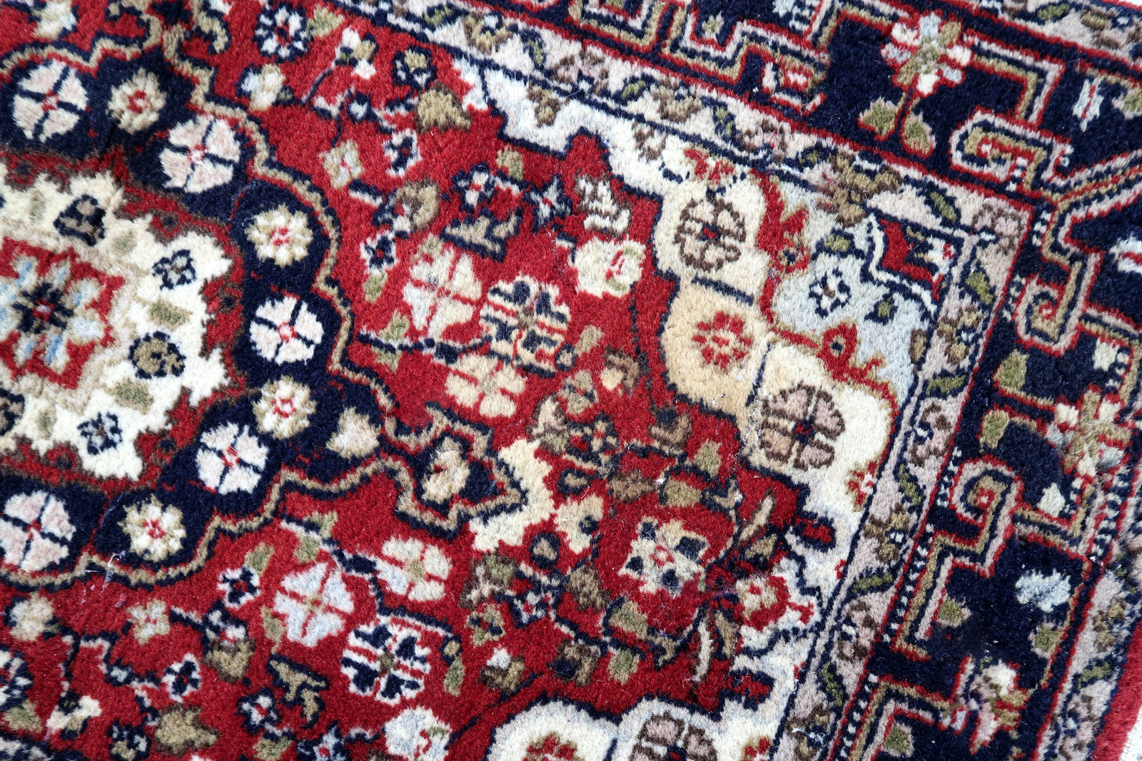 Handmade vintage Middle Eastern rug in traditional medallion design. The rug has been made in wool in the end of 20th century. It is in original good condition