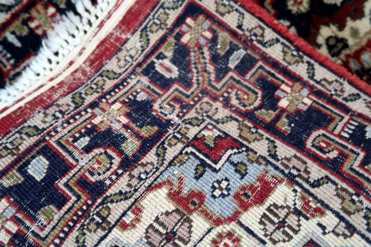 Handmade vintage Middle Eastern rug in traditional medallion design. The rug has been made in wool in the end of 20th century. It is in original good condition