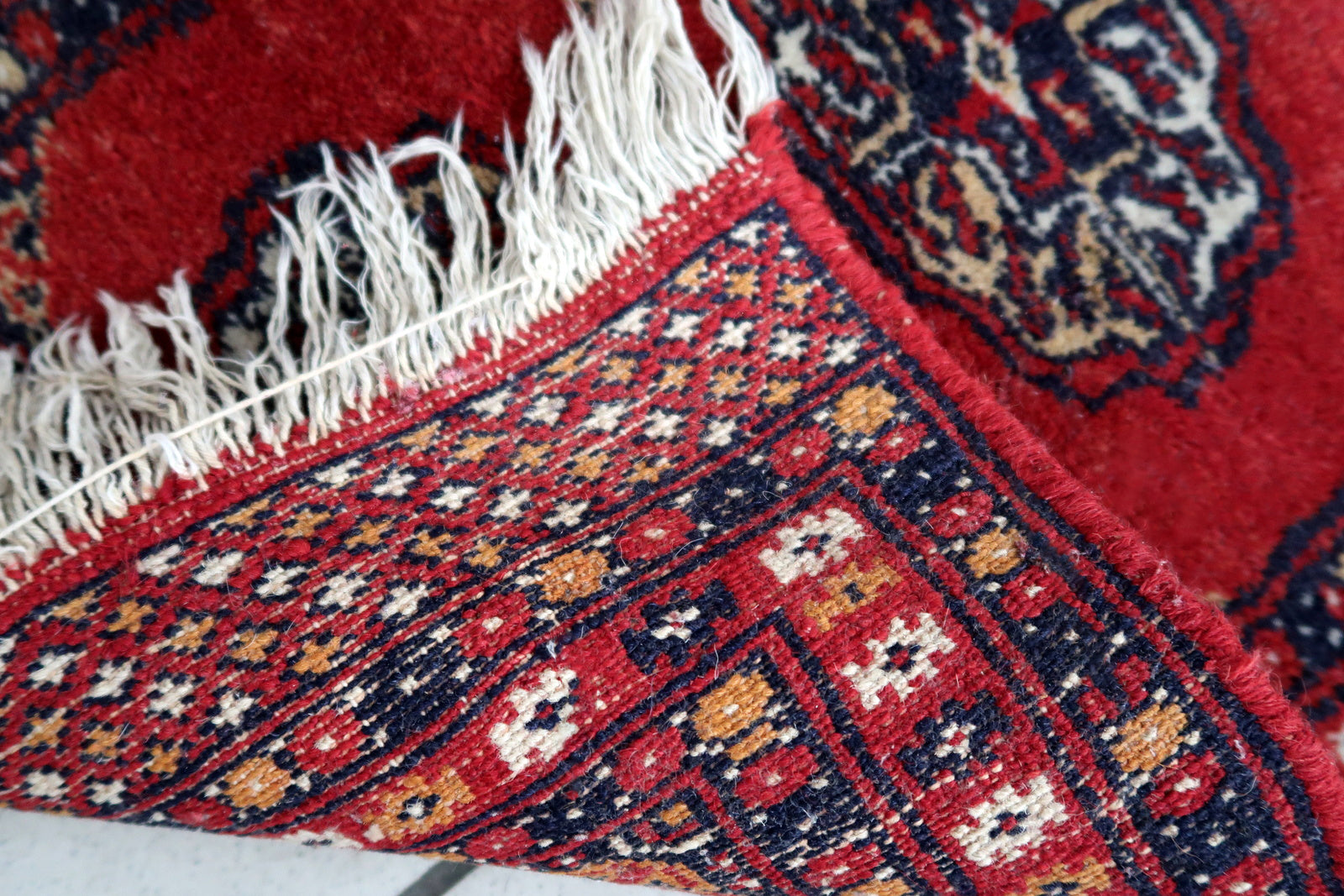 Handmade vintage Pakistani Lahore mat in traditional medallion design. The rug has been made in wool in the end of 20th century. It is in original good condition