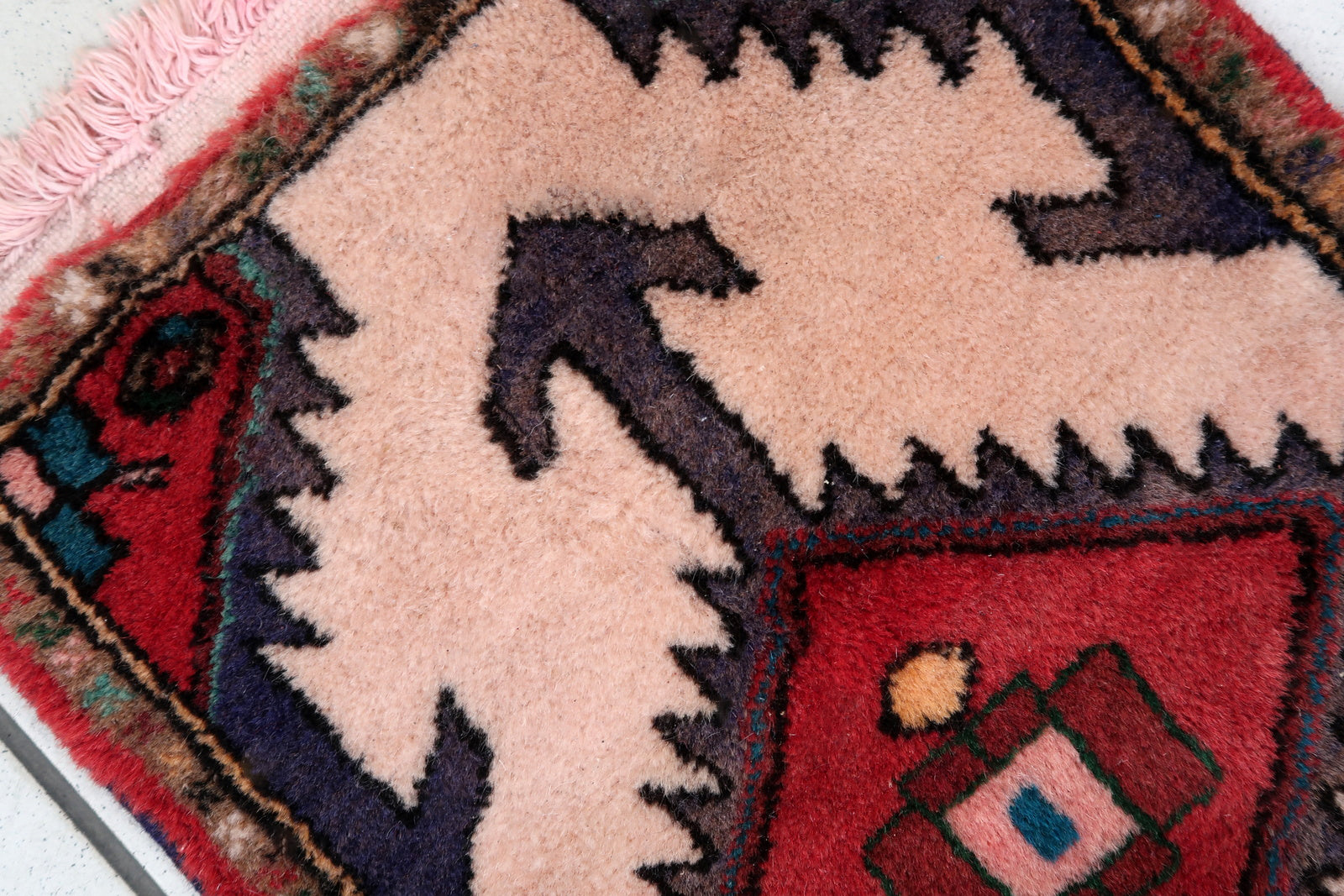 Handmade vintage Middle Eastern rug in traditional medallion design. The rug has been made in wool in the end of 20th century. It is in original good condition