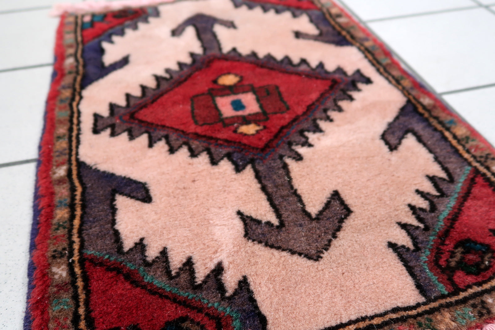 Handmade vintage Middle Eastern rug in traditional medallion design. The rug has been made in wool in the end of 20th century. It is in original good condition