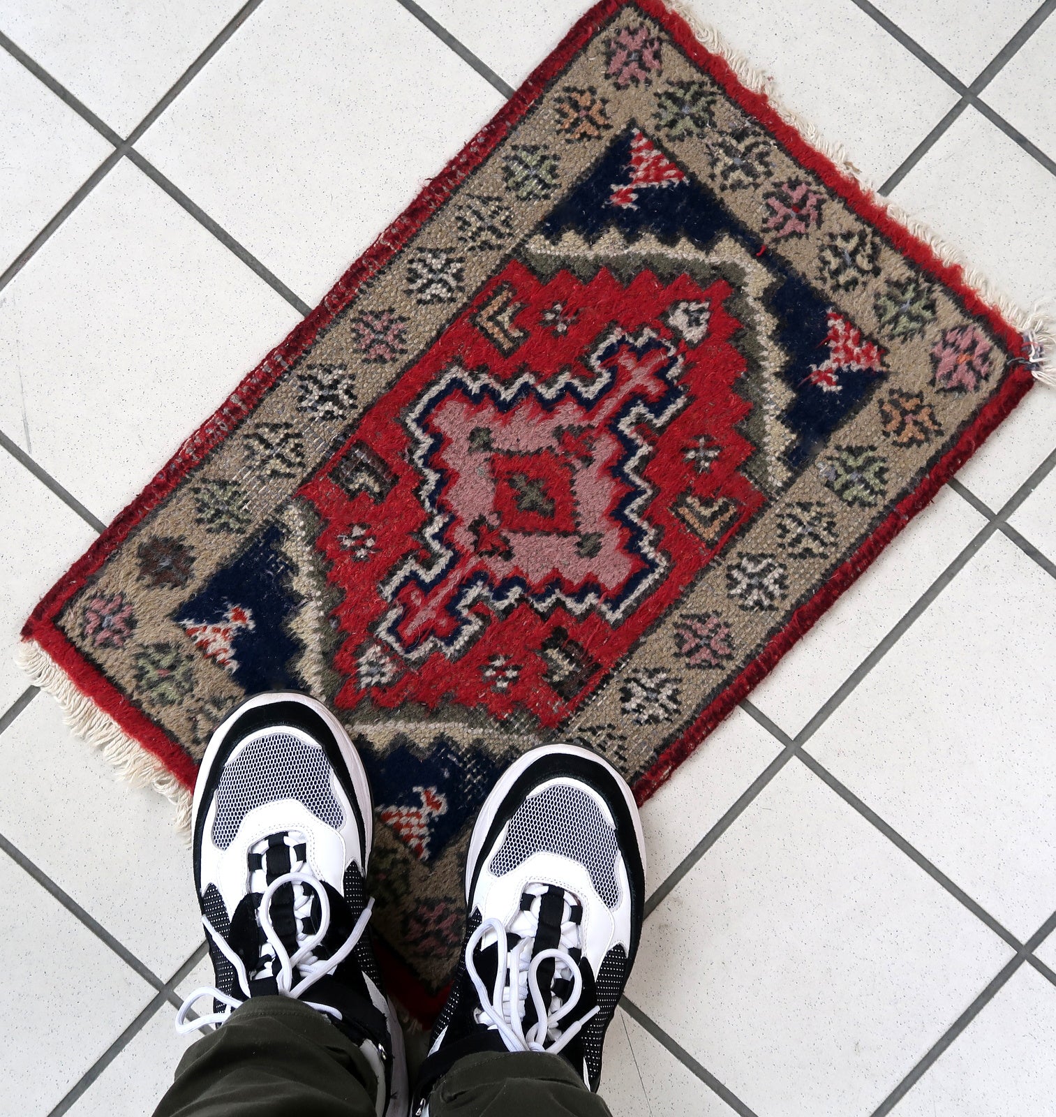 Handmade vintage Middle Eastern rug in traditional medallion design. The rug has been made in wool in the end of 20th century. It is in original condition, has some low pile.
