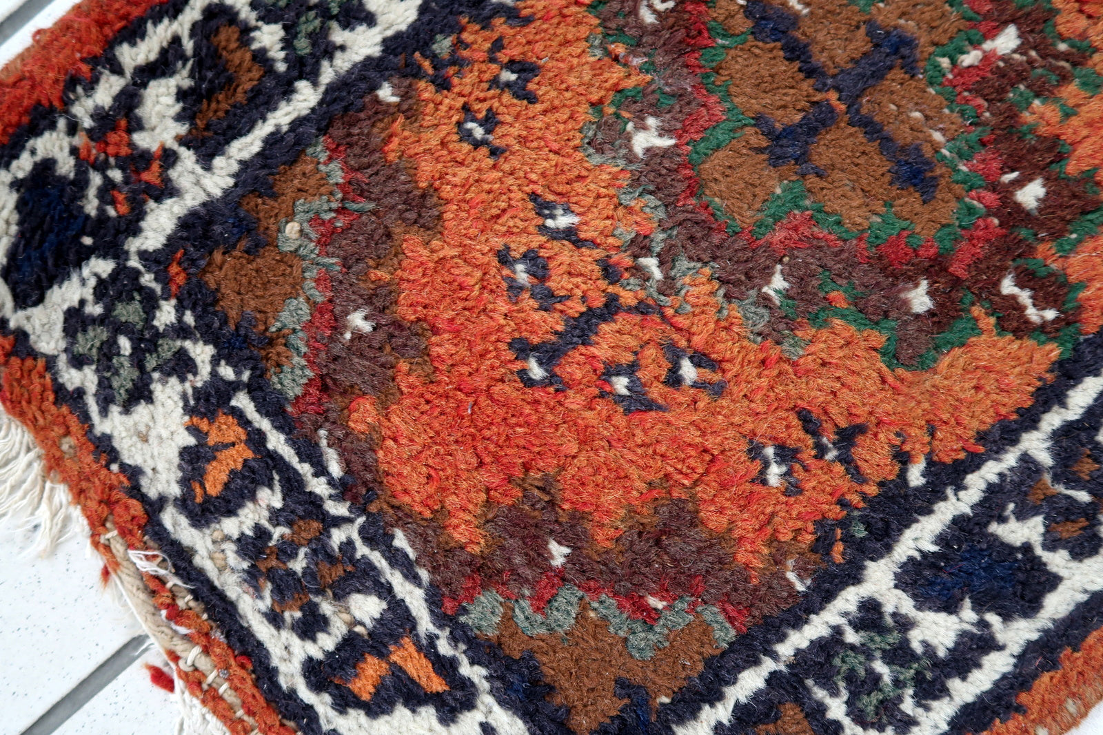Handmade vintage Middle Eastern rug in traditional medallion design. The rug has been made in wool in the end of 20th century. It is in original condition, has some low pile.