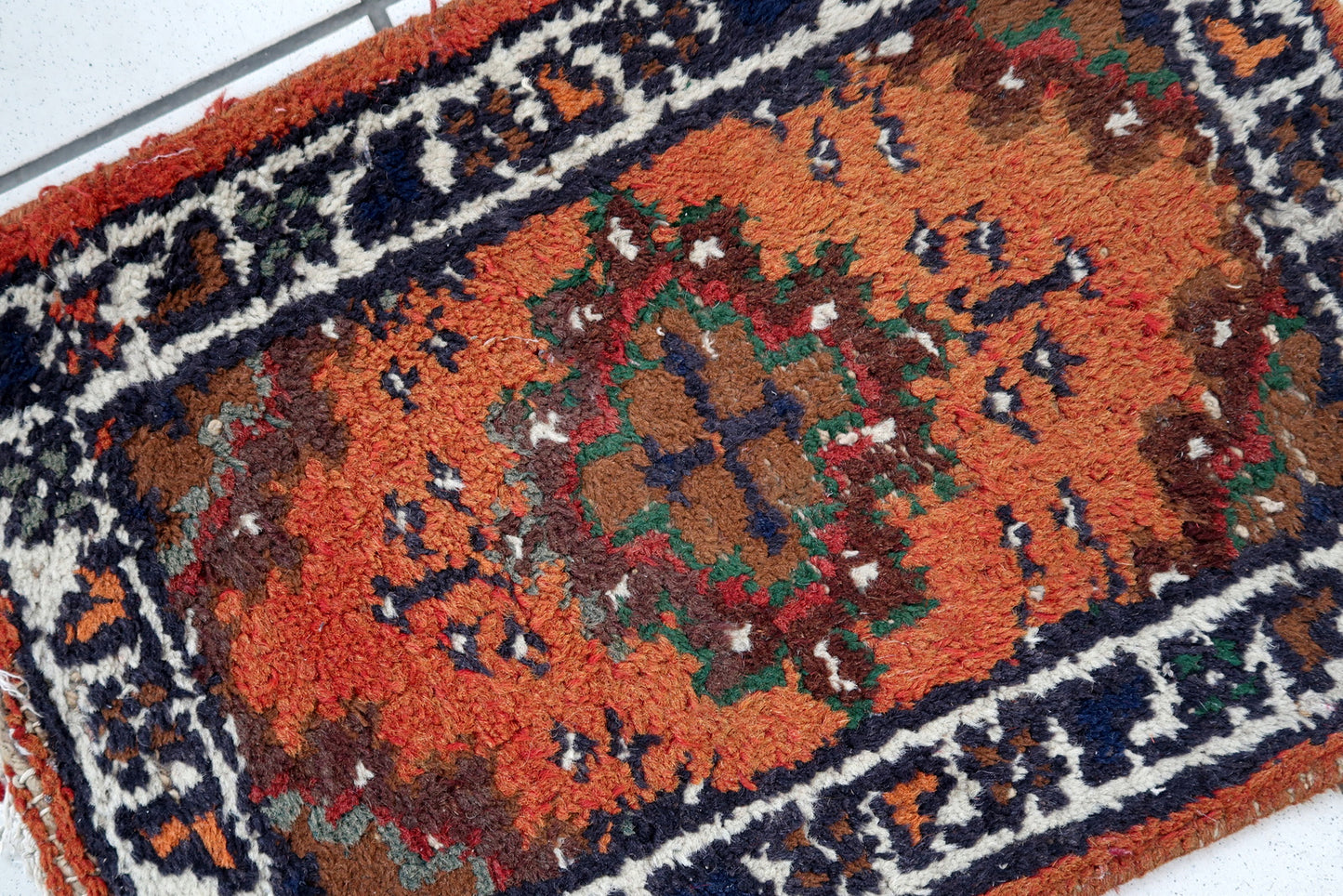 Handmade vintage Middle Eastern rug in traditional medallion design. The rug has been made in wool in the end of 20th century. It is in original condition, has some low pile.