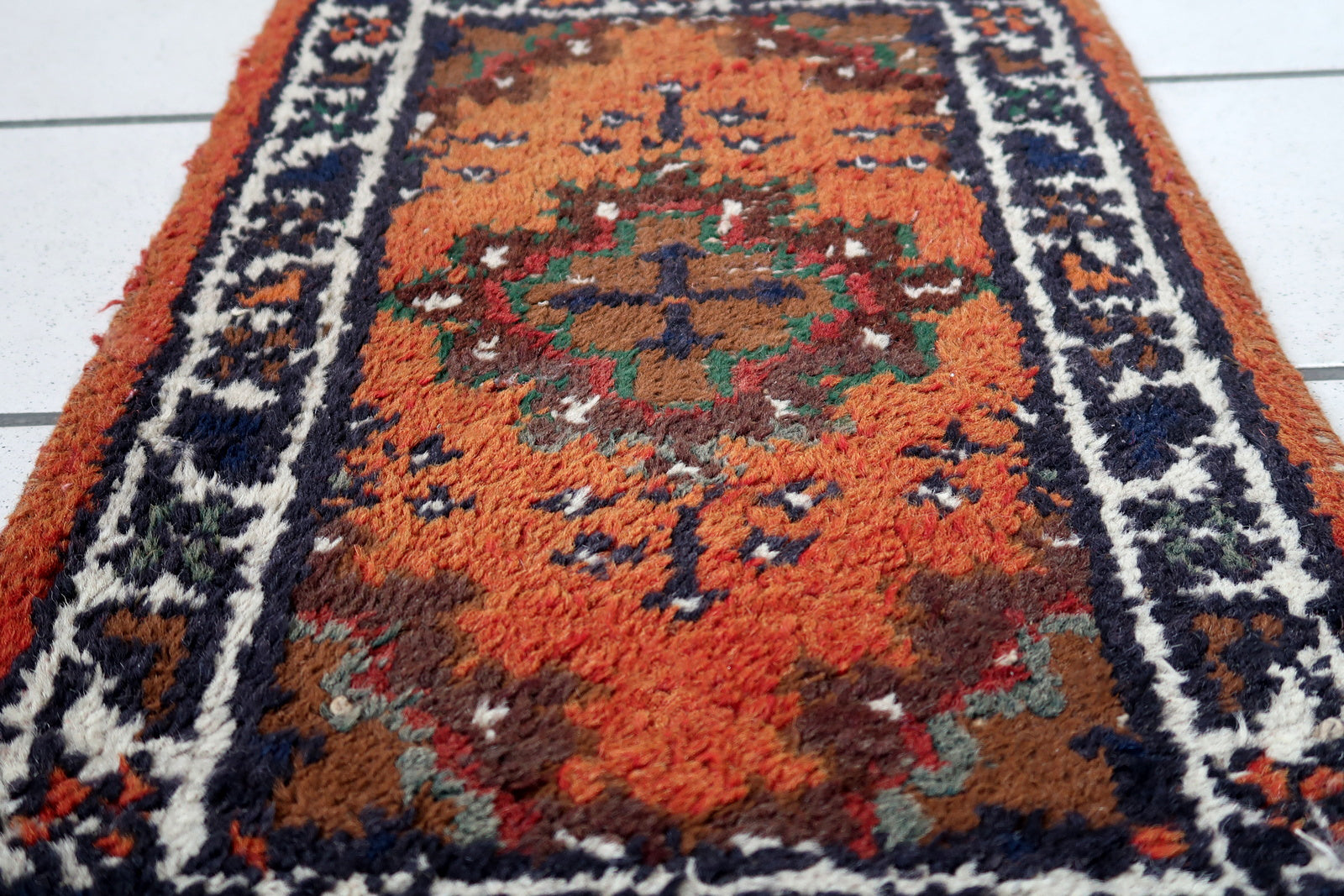 Handmade vintage Middle Eastern rug in traditional medallion design. The rug has been made in wool in the end of 20th century. It is in original condition, has some low pile.