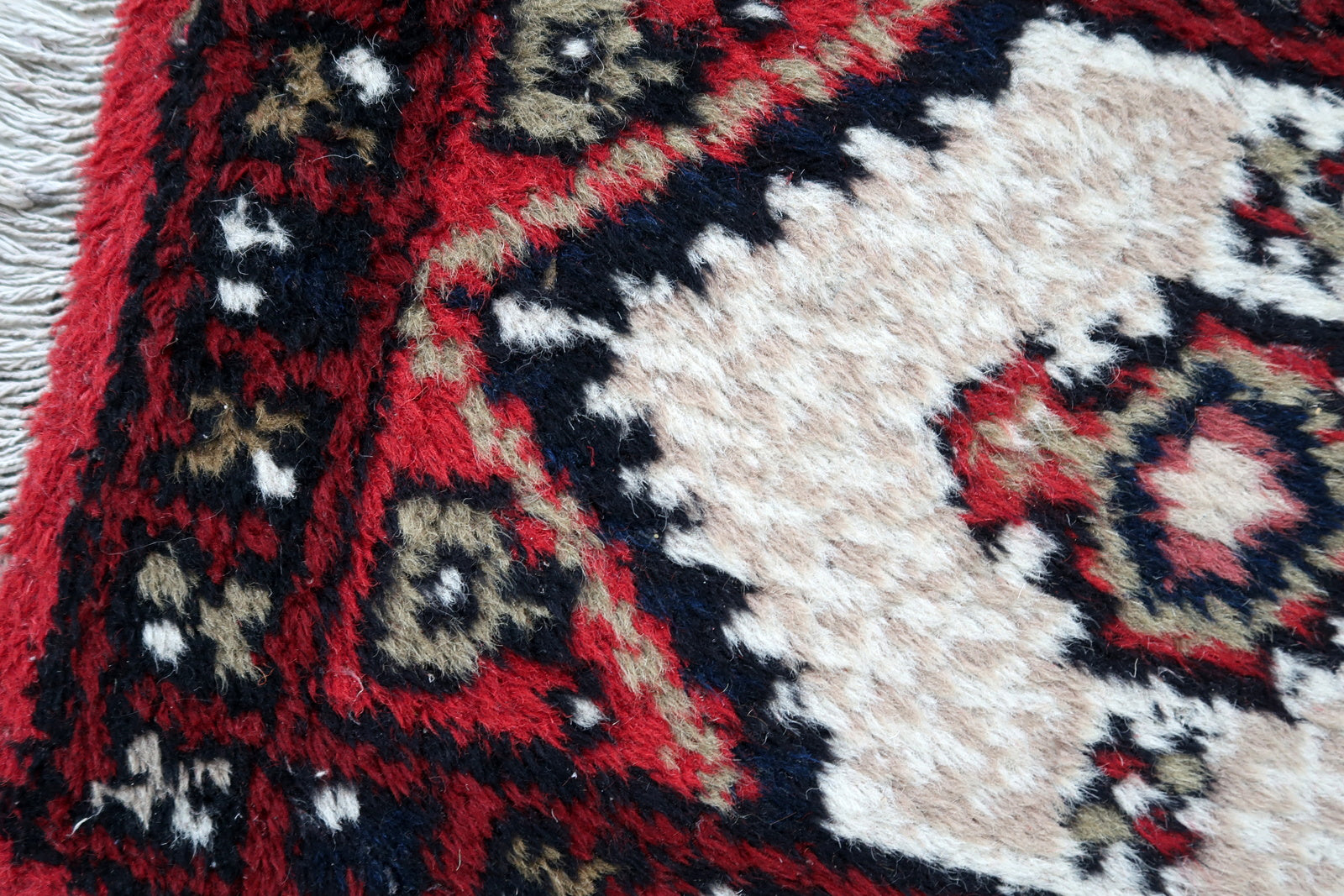 Handmade vintage Middle Eastern rug in traditional medallion design. The rug has been made in wool in the end of 20th century. It is in original condition, has some low pile.