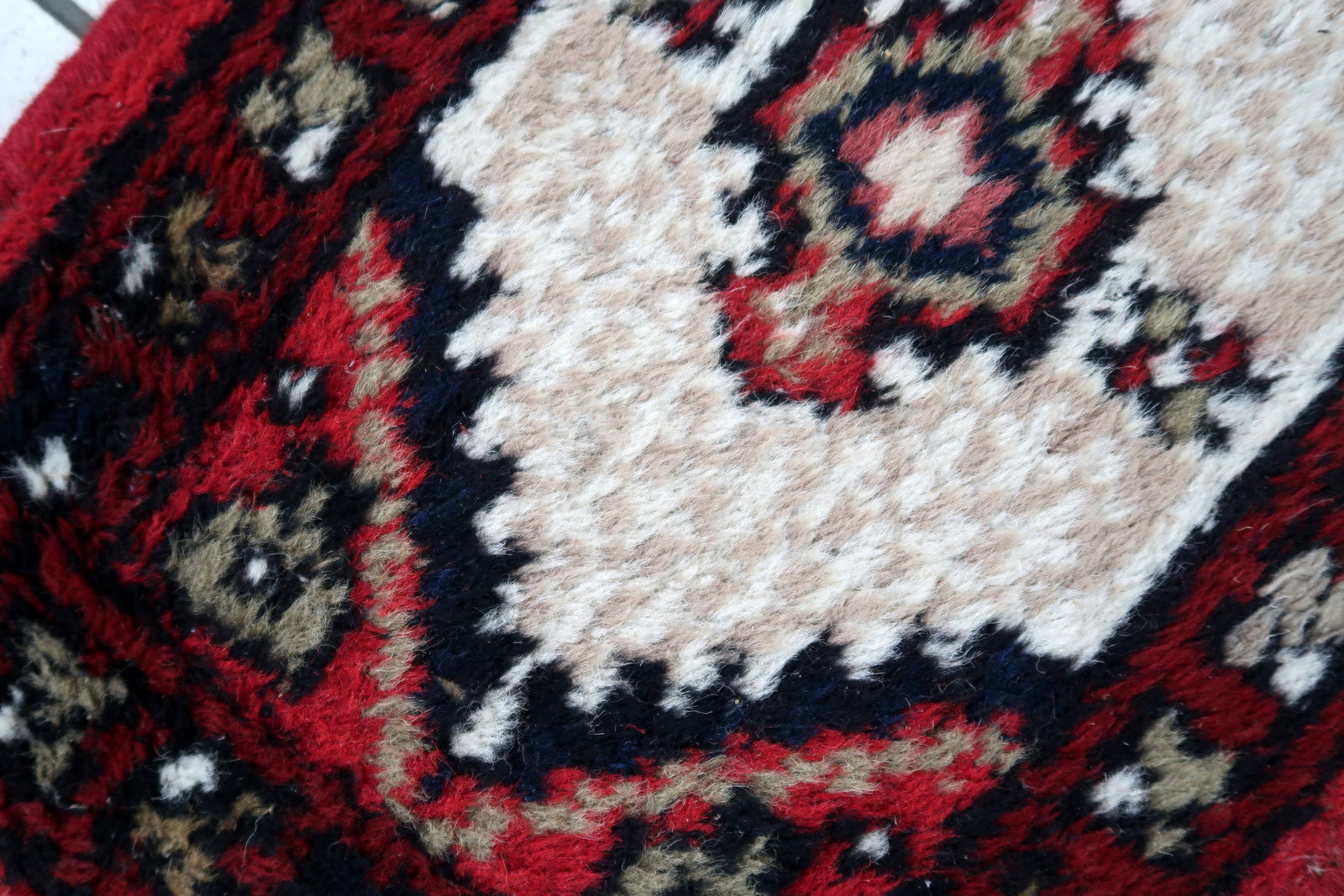 Handmade vintage Middle Eastern rug in traditional medallion design. The rug has been made in wool in the end of 20th century. It is in original condition, has some low pile.