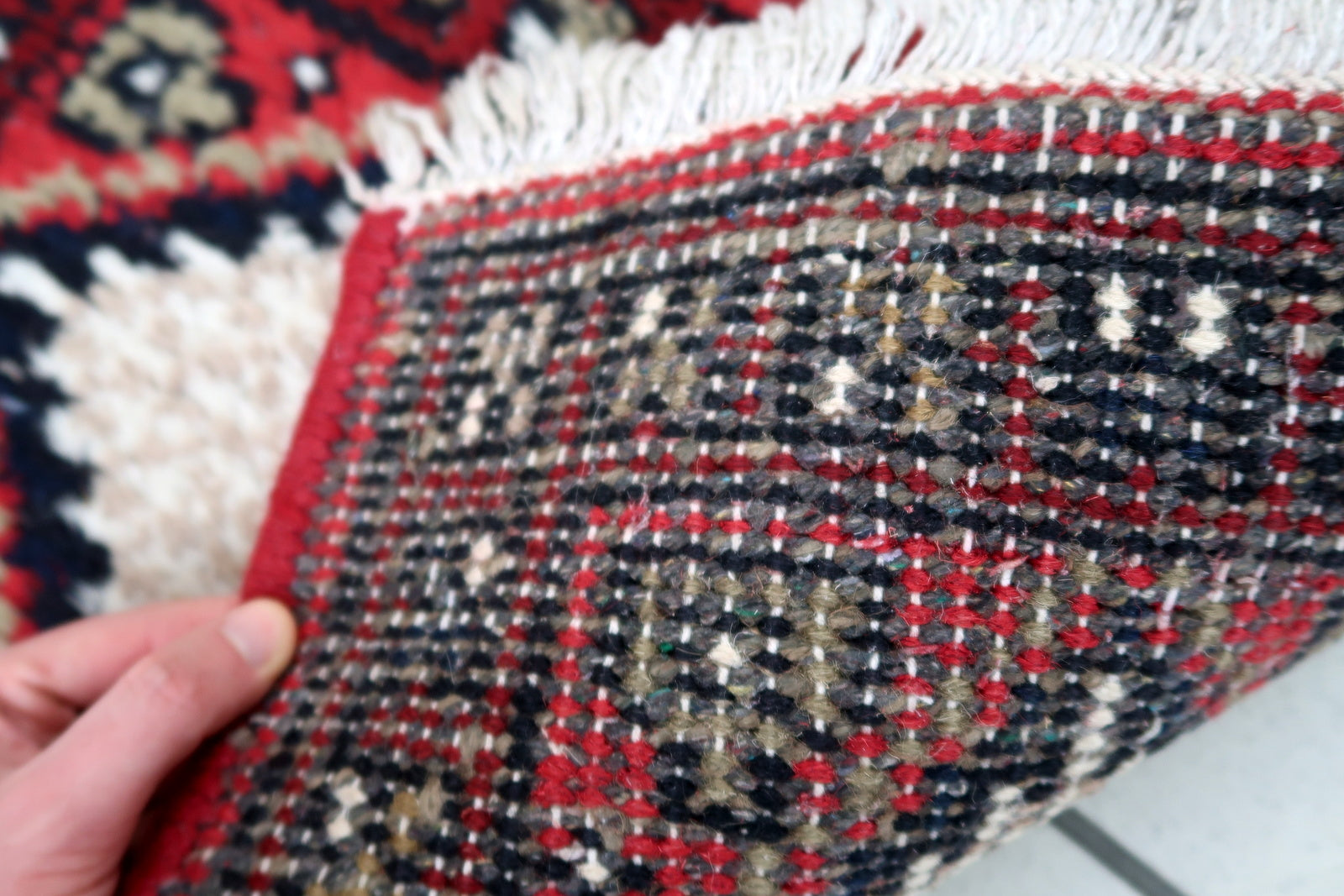Handmade vintage Middle Eastern rug in traditional medallion design. The rug has been made in wool in the end of 20th century. It is in original condition, has some low pile.