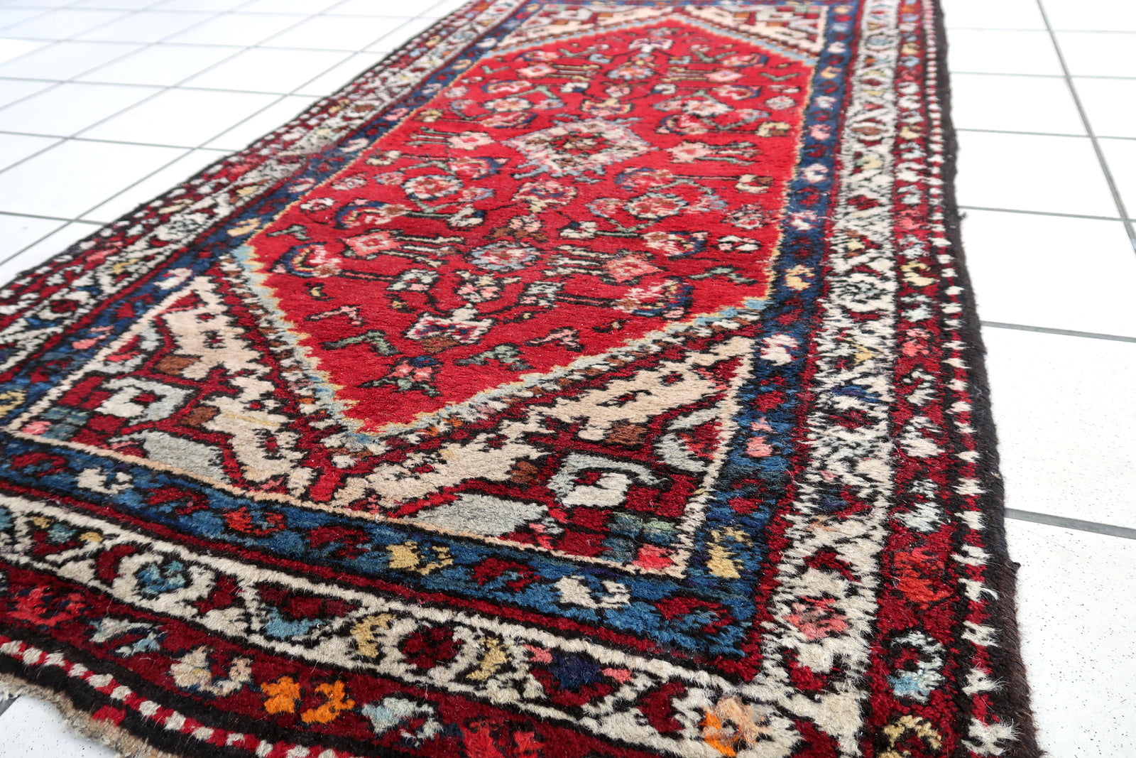 Handmade vintage Persian Malayer rug in red color. The rug has been made in wool in the middle of 20th century. It is in original condition, it has some signs of age.