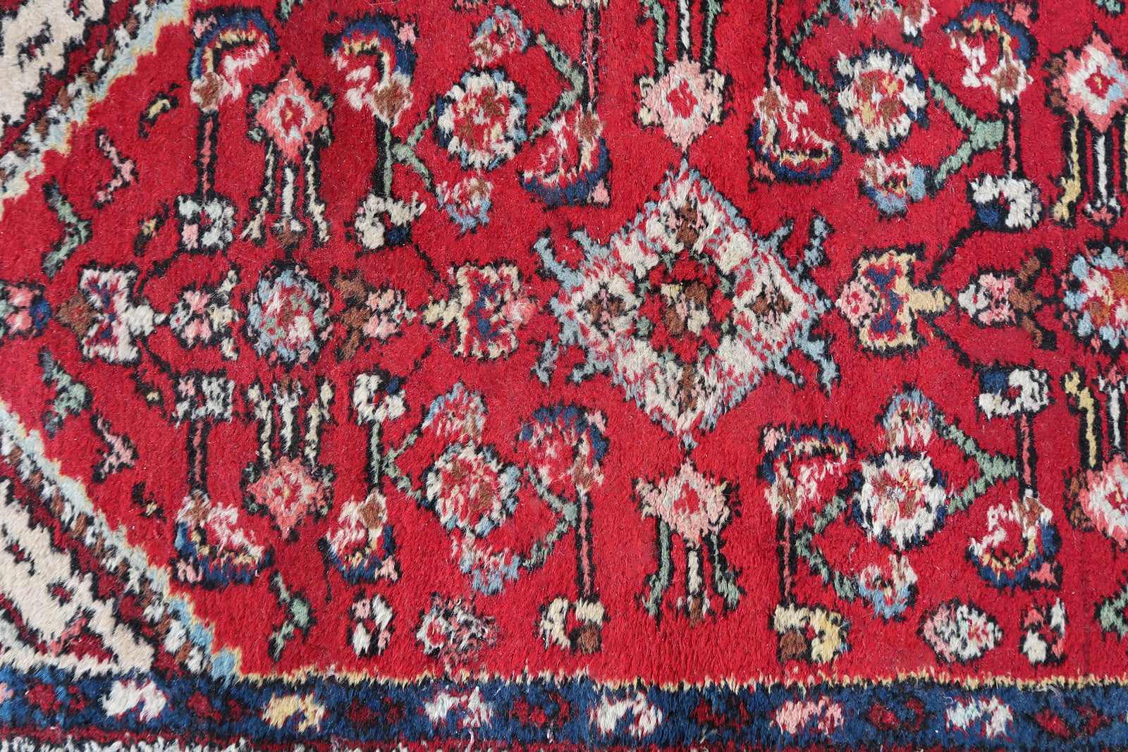 Handmade vintage Persian Malayer rug in red color. The rug has been made in wool in the middle of 20th century. It is in original condition, it has some signs of age.