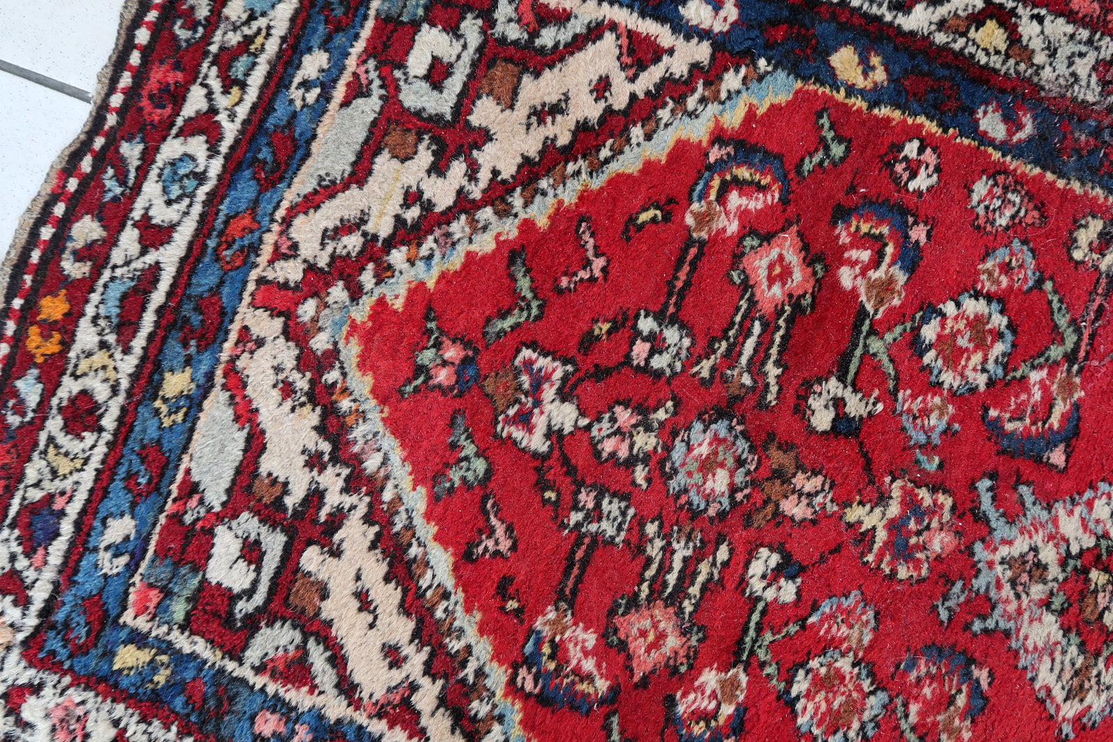 Handmade vintage Persian Malayer rug in red color. The rug has been made in wool in the middle of 20th century. It is in original condition, it has some signs of age.