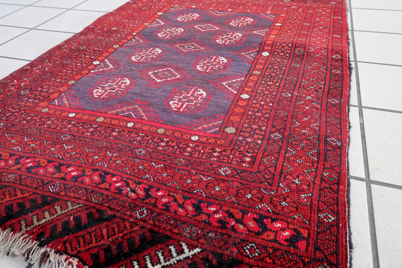 Handmade semi-antique Afghan Ersari rug in traditional design. The rug has been made in wool in the end of 20th century. It is in original condition, has some signs of age.