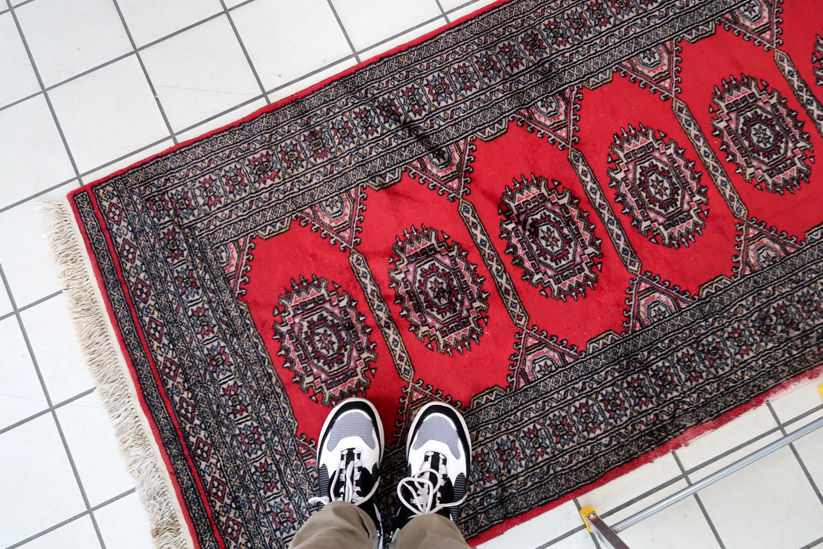 Handmade vintage Uzbek Bukhara rug in red color. The rug has been made in wool in the end of 20th century. It is in original condition, it has some signs of age.