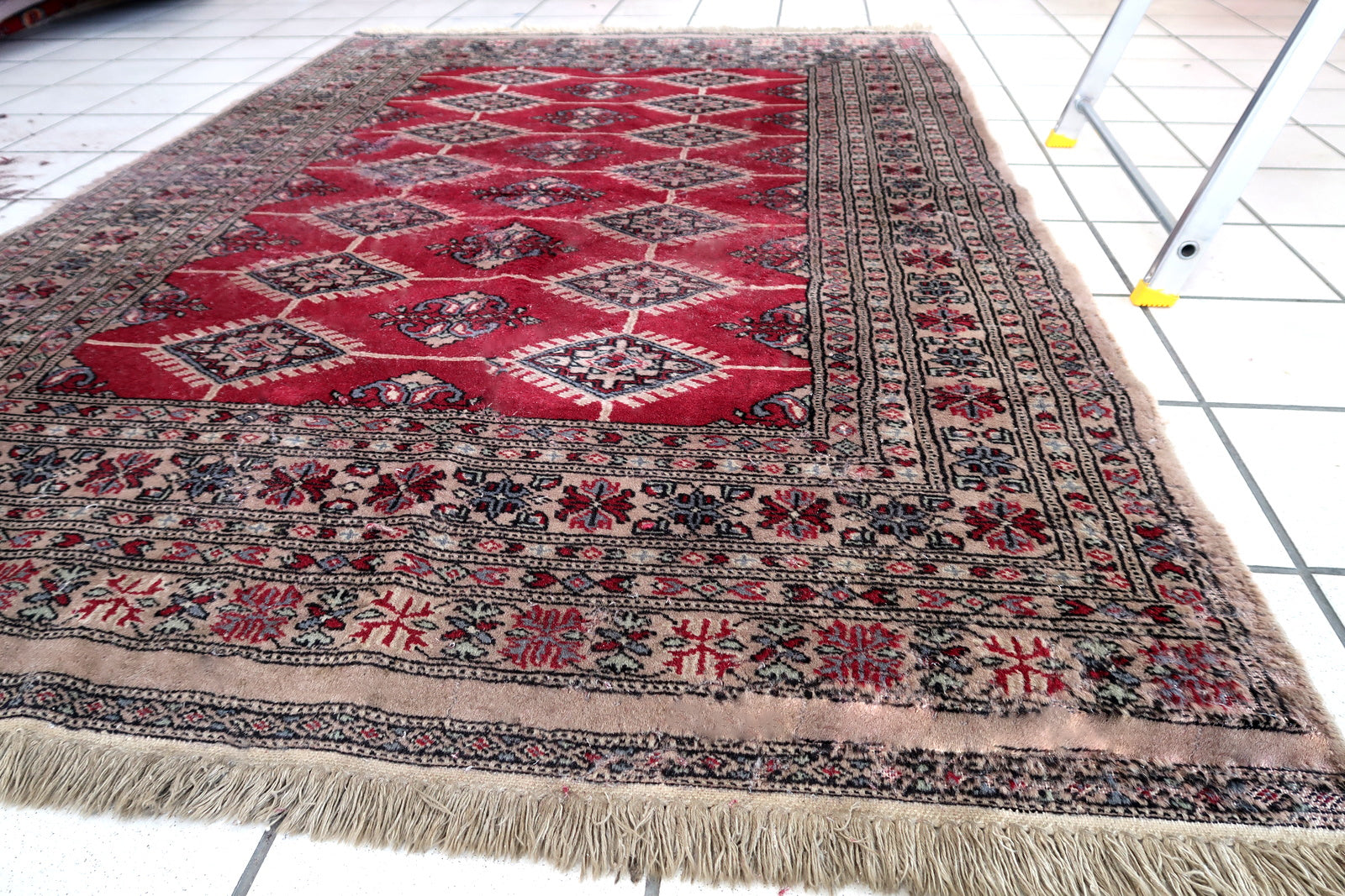 Handmade vintage Uzbek Bukhara rug in red color. The rug has been made in wool in the end of 20th century. It is in original condition, it has some signs of age.