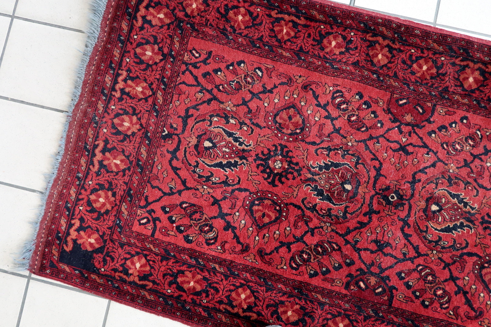 Handmade vintage Afghan Ersari runner in red color. The rug has been made in wool in the end of 20th century. It is in original good condition.