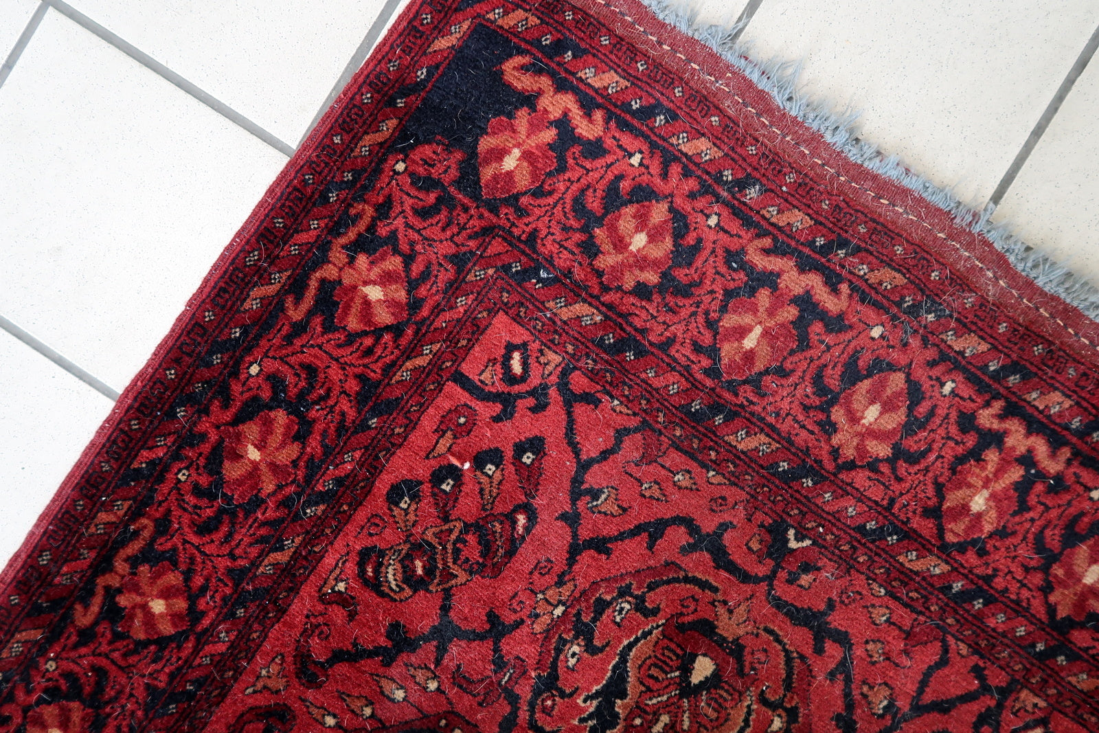 Handmade vintage Afghan Ersari runner in red color. The rug has been made in wool in the end of 20th century. It is in original good condition.