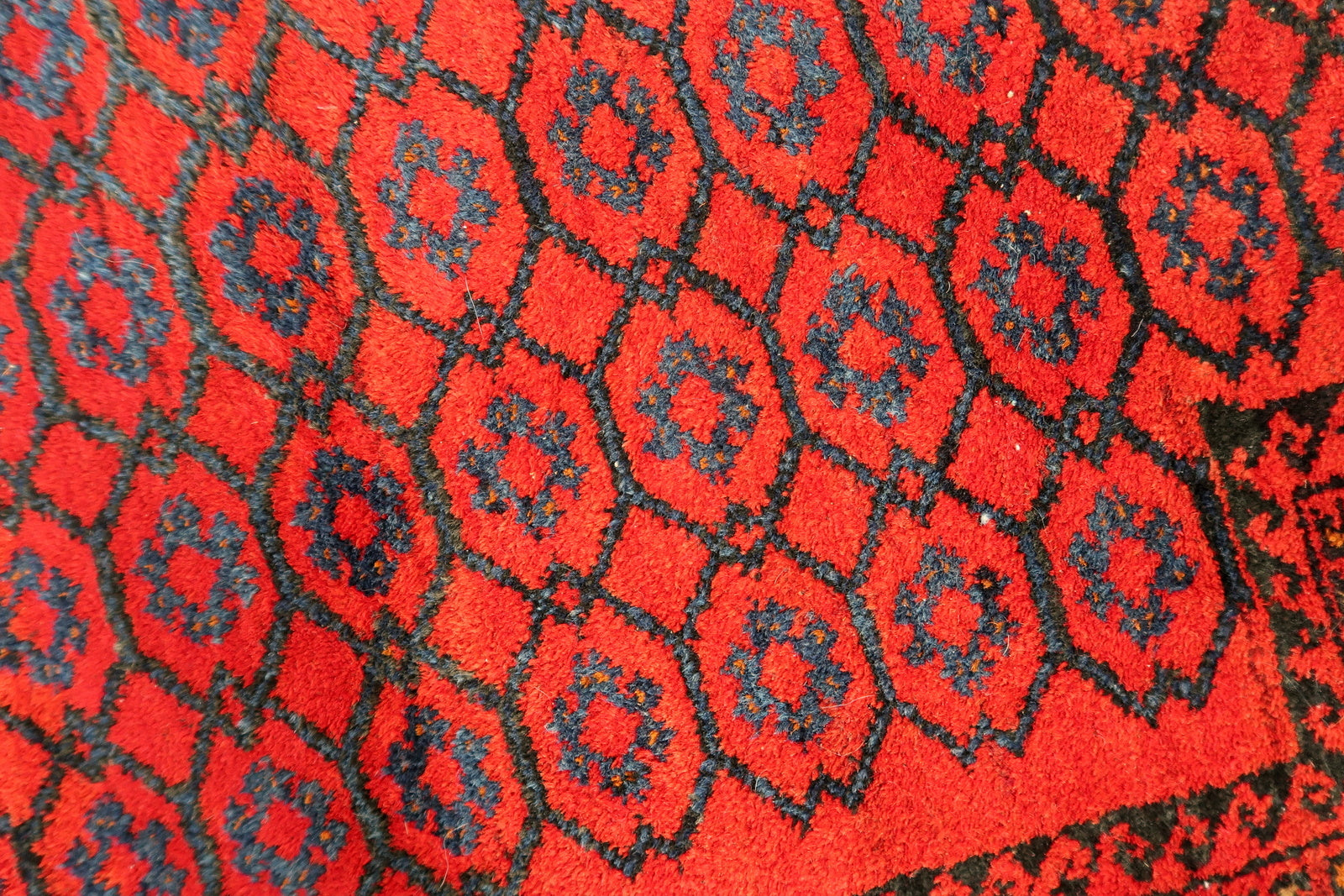 Handmade vintage Afghan Baluch rug in red color and prayer design. The rug has been made in wool in the middle of 20th century. It is in original good condition.
