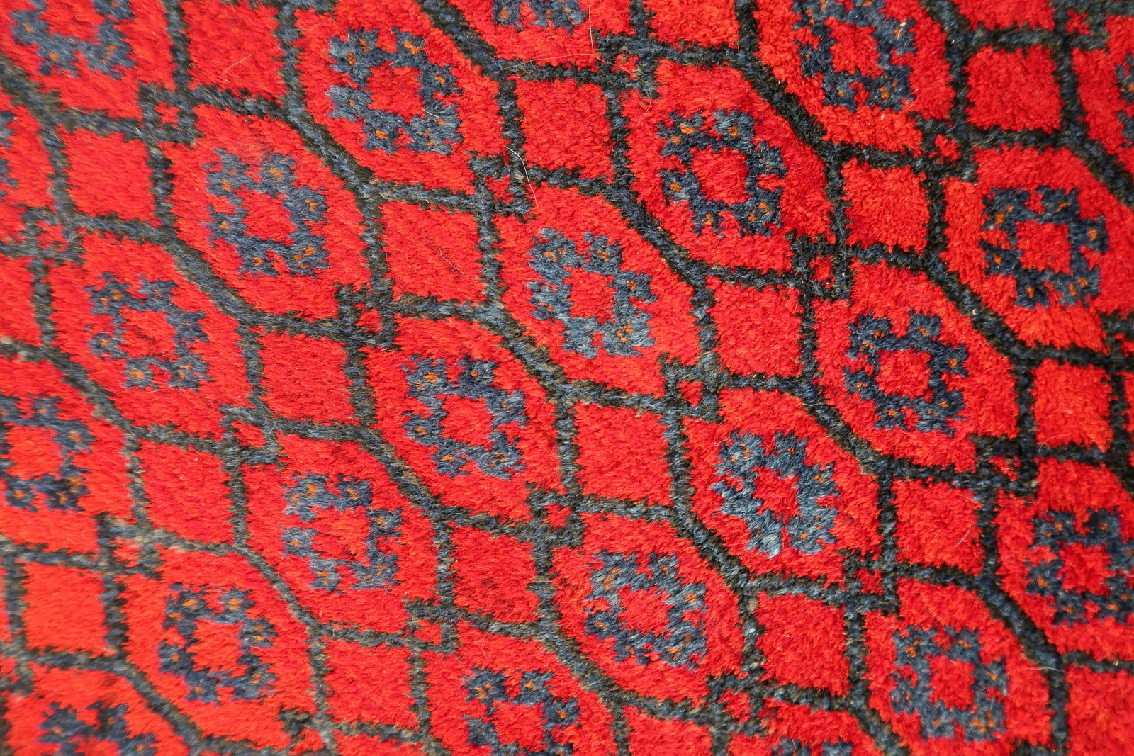 Handmade vintage Afghan Baluch rug in red color and prayer design. The rug has been made in wool in the middle of 20th century. It is in original good condition.