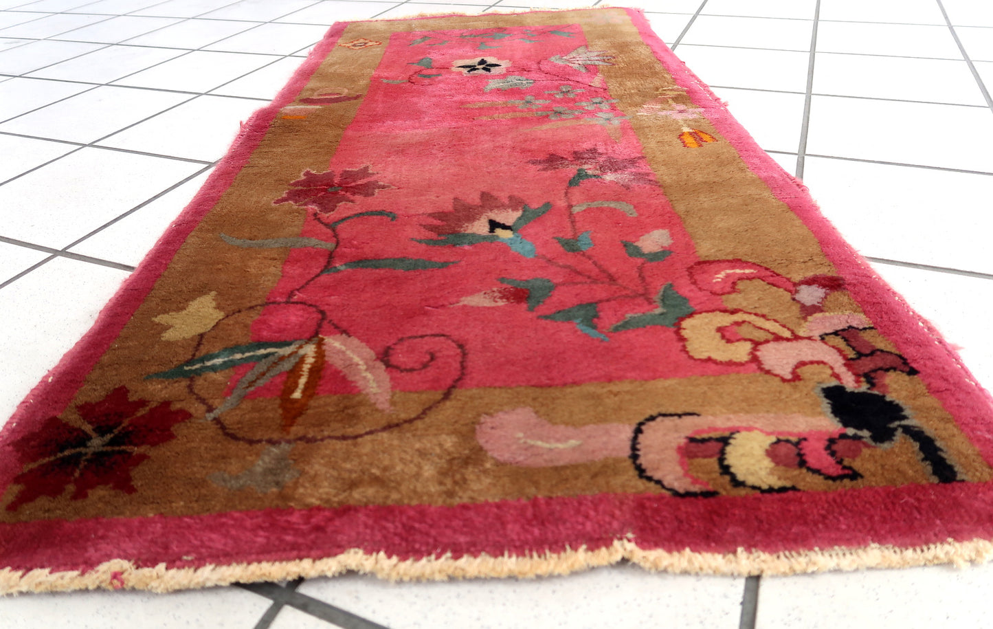 Handmade antique Art Deco Chinese rug in good condition. The rug has been made in China in fuchsia shade. The rug is from the beginning of 20th century.