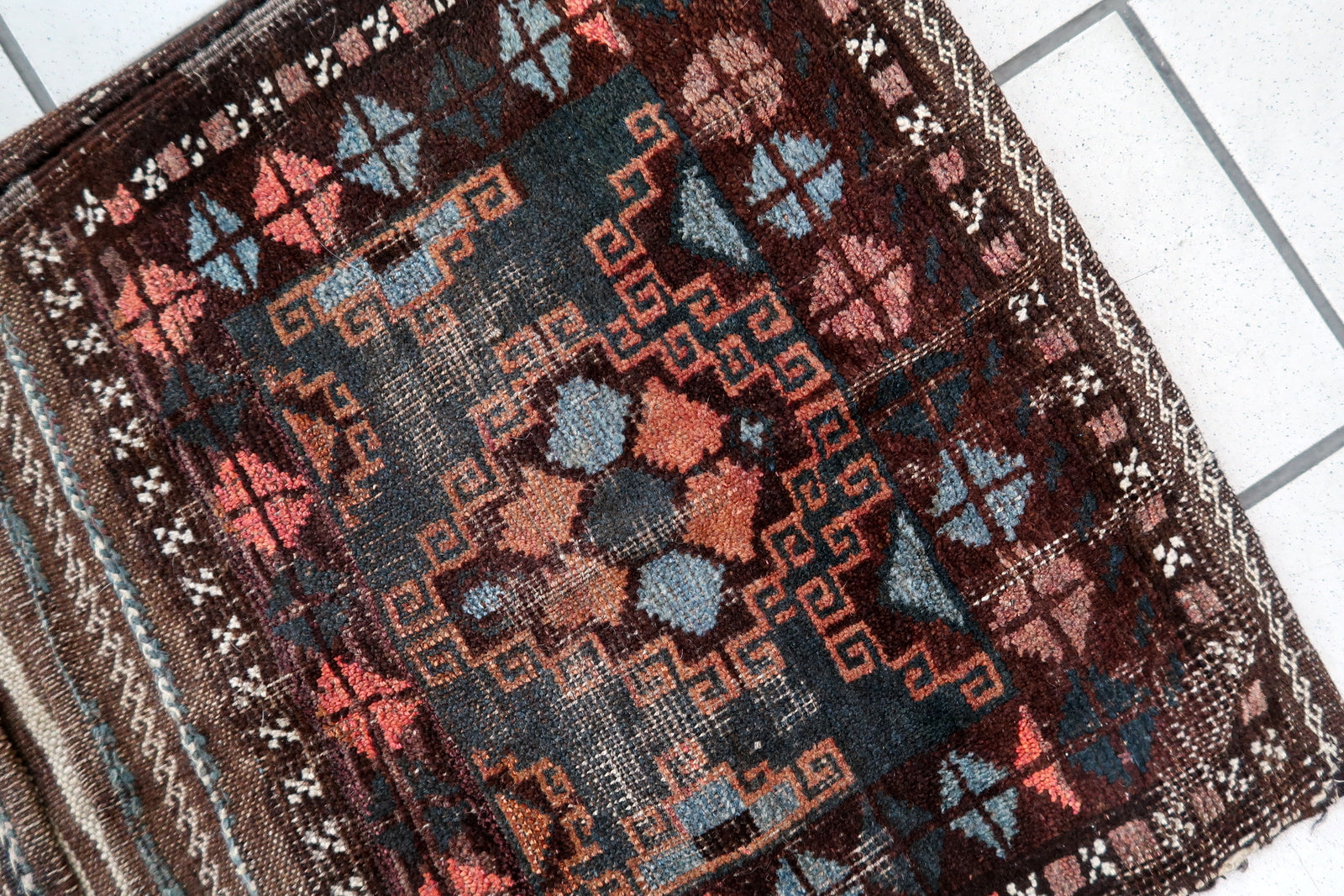 Handmade antique Afghan Baluch saddle bag in original condition, it has some age wear. The bag has been made in the beginning of the 20th century in original combination of colors.
