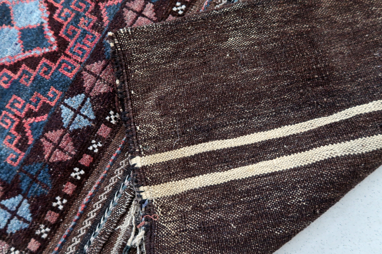 Handmade antique Afghan Baluch saddle bag in original condition, it has some age wear. The bag has been made in the beginning of the 20th century in original combination of colors.