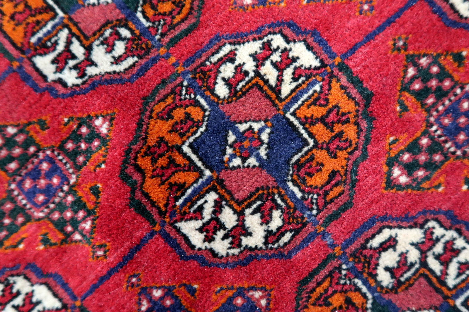 Handmade vintage Turkmen Tekke rug in wool and traditional design. The rug is from the end of 20th century in original good condition. The sides of the rug are not even.