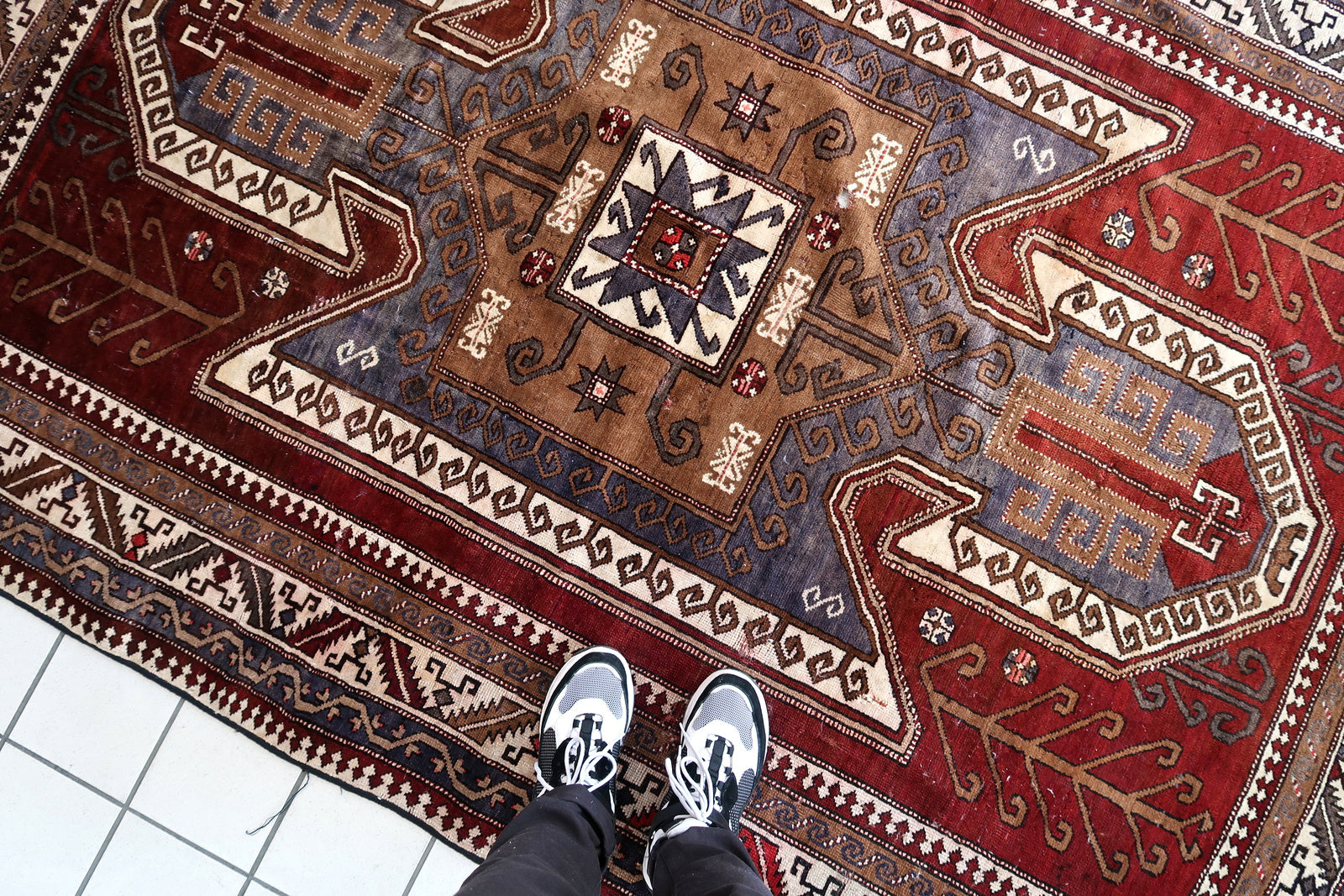 Handmade vintage Caucasian Kazak rug deep red color and large medallion. The rug is from the beginning of 20th century, it is in good condition. 