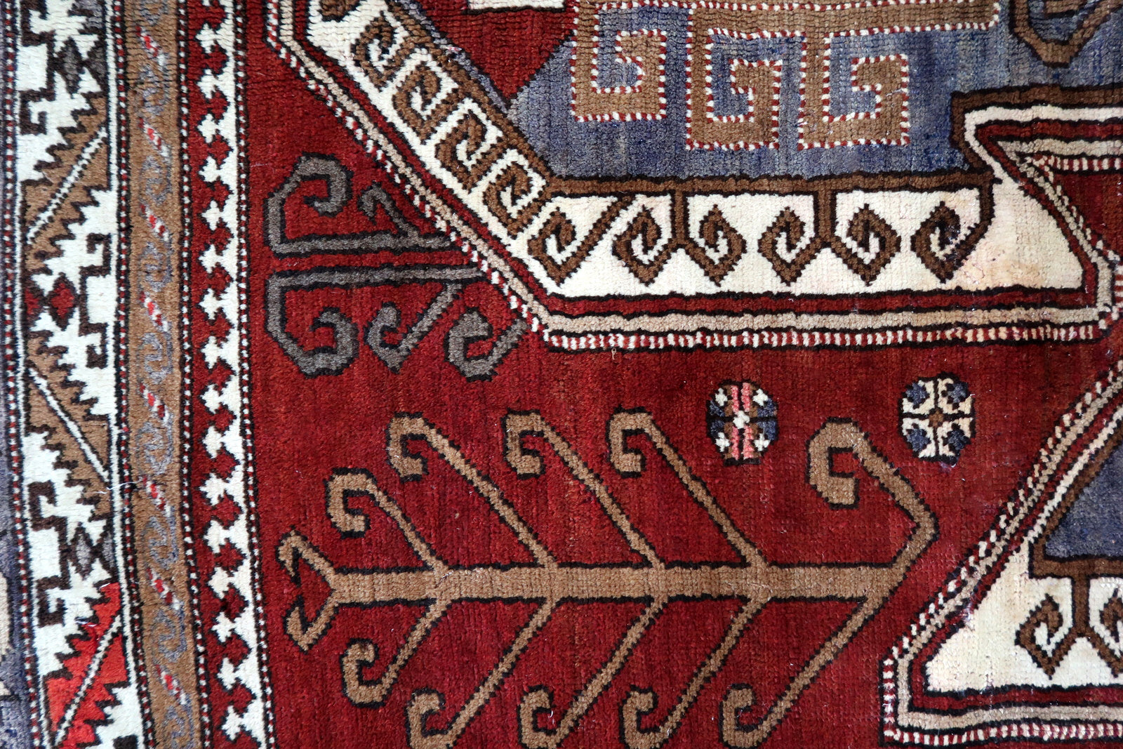 Handmade vintage Caucasian Kazak rug deep red color and large medallion. The rug is from the beginning of 20th century, it is in good condition. 