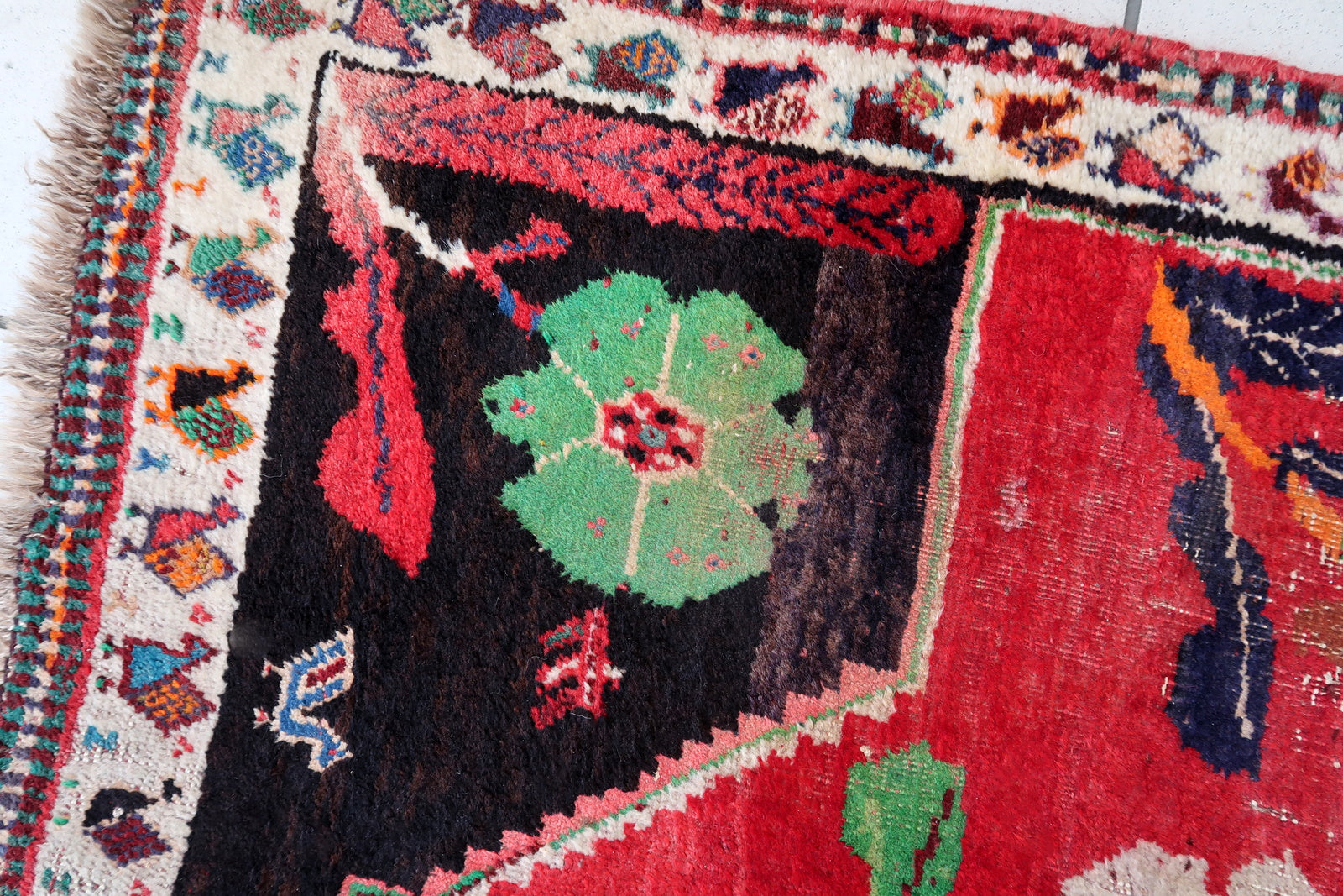 Handmade vintage Persian Gashkai rug in unusual design and bright red and chocolate brown color. The rug is from the end of 20th century, it is in original condition, has some low pile. 