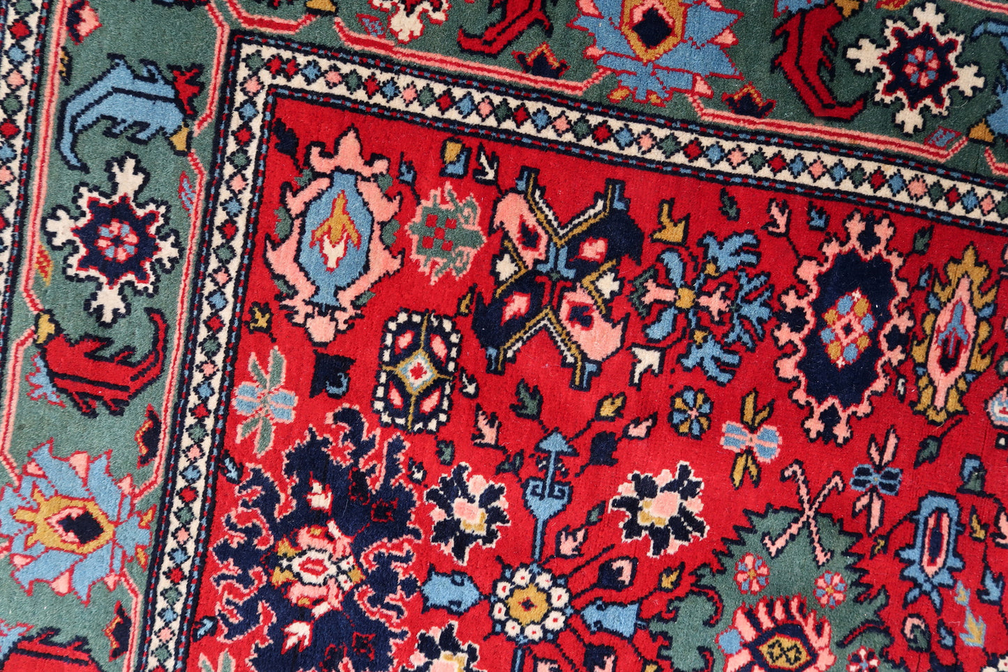 Handmade vintage Persian Tabriz rug in bright red and green colors. The rug is from the end of 20th century, it is in original good condition.