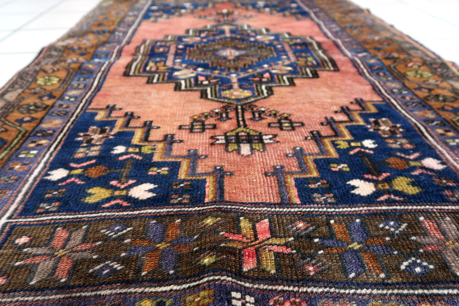 Handmade vintage Afghan Baluch rug in pink and olive colors. The rug is from the beginning of 20th century, it is in original good condition.