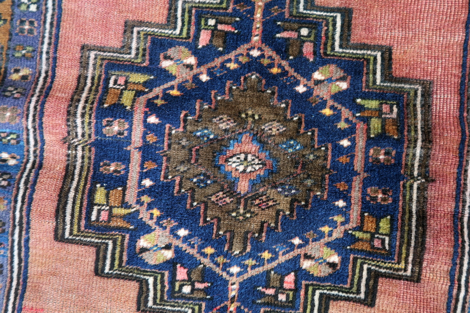 Handmade vintage Afghan Baluch rug in pink and olive colors. The rug is from the beginning of 20th century, it is in original good condition.