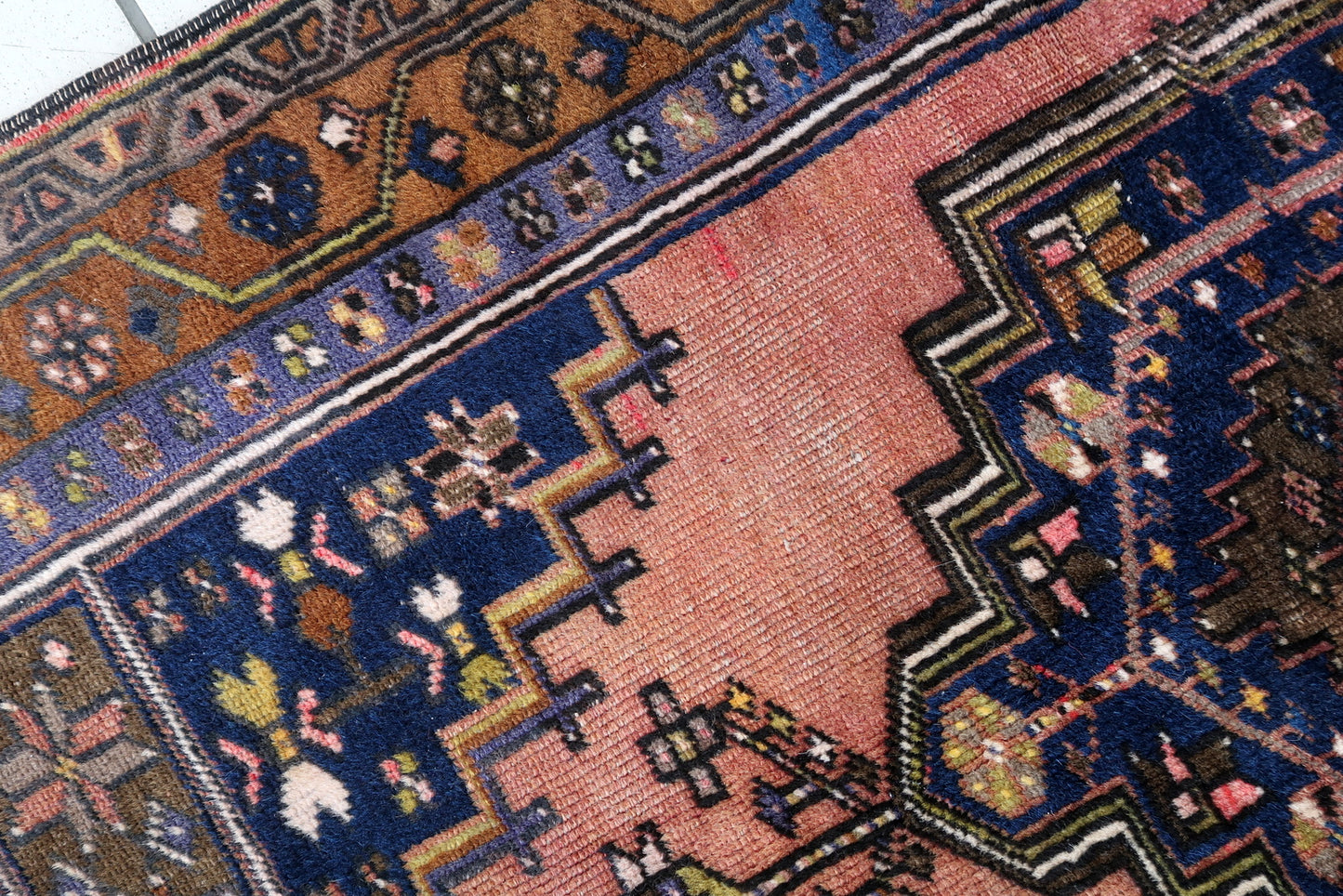 Handmade vintage Afghan Baluch rug in pink and olive colors. The rug is from the beginning of 20th century, it is in original good condition.