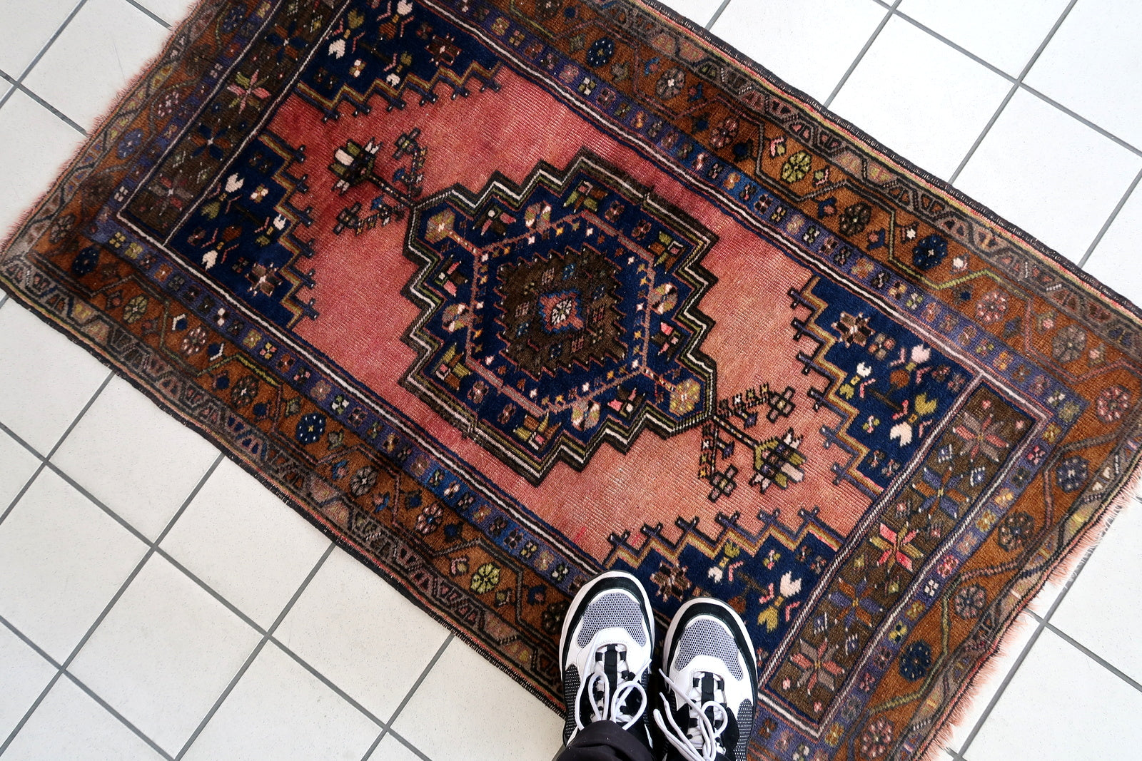 Handmade vintage Afghan Baluch rug in pink and olive colors. The rug is from the beginning of 20th century, it is in original good condition.