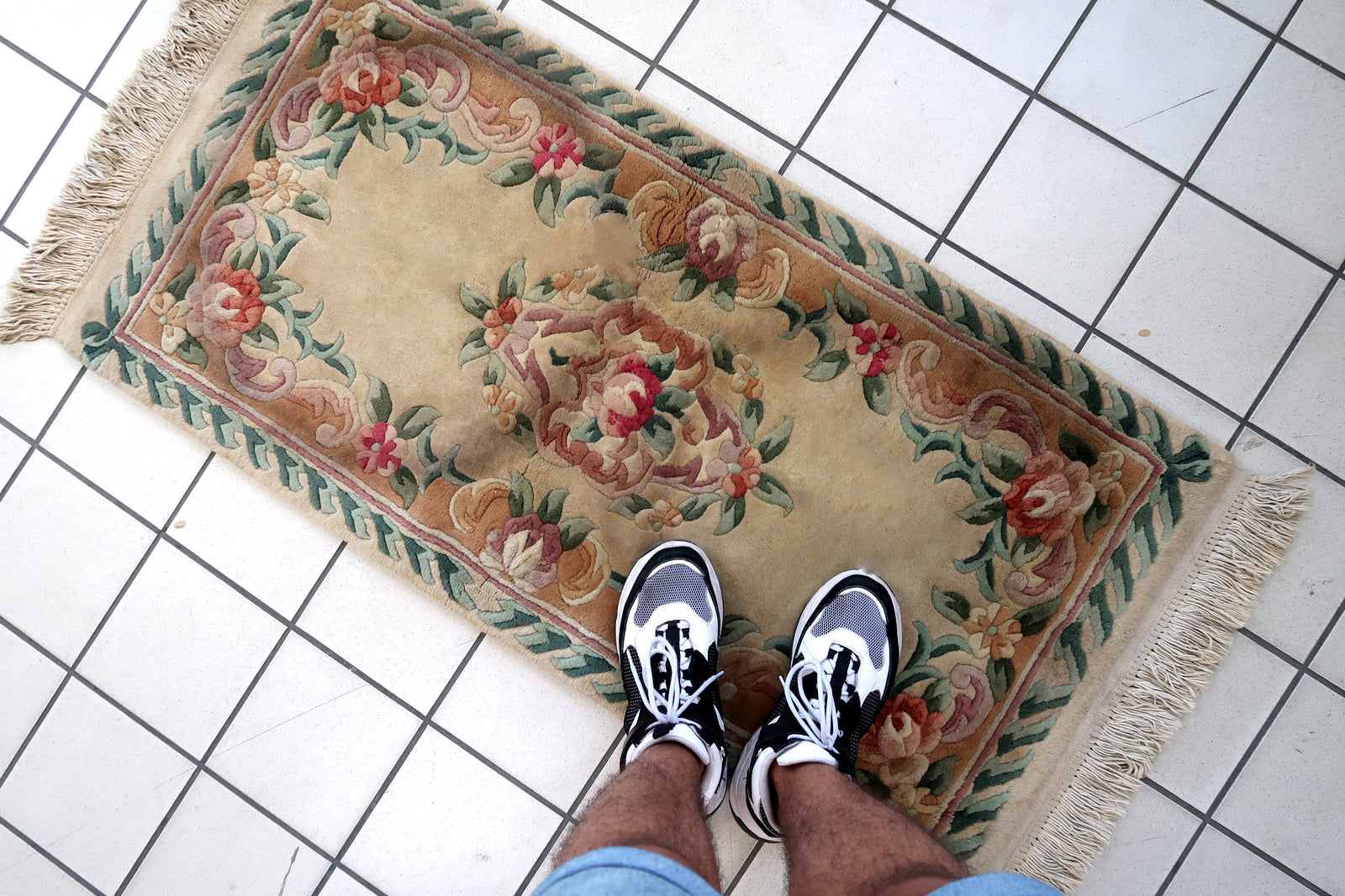 Handmade vintage Art Deco Chinese rug in beige, green and red colors. The rug is from the end of 20th century in original good condition. This rug has classic floral design with the touch of French style.