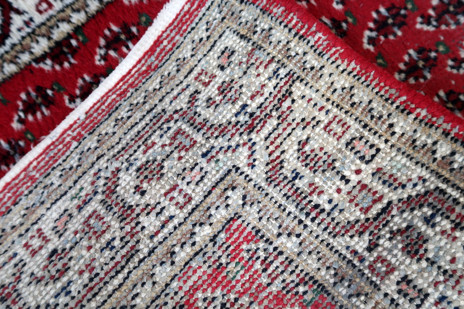 Handmade vintage Indian Seraband rug in red color and all-over design. The rug has been made in the end of 20th century. It is in original condition, has some low pile.