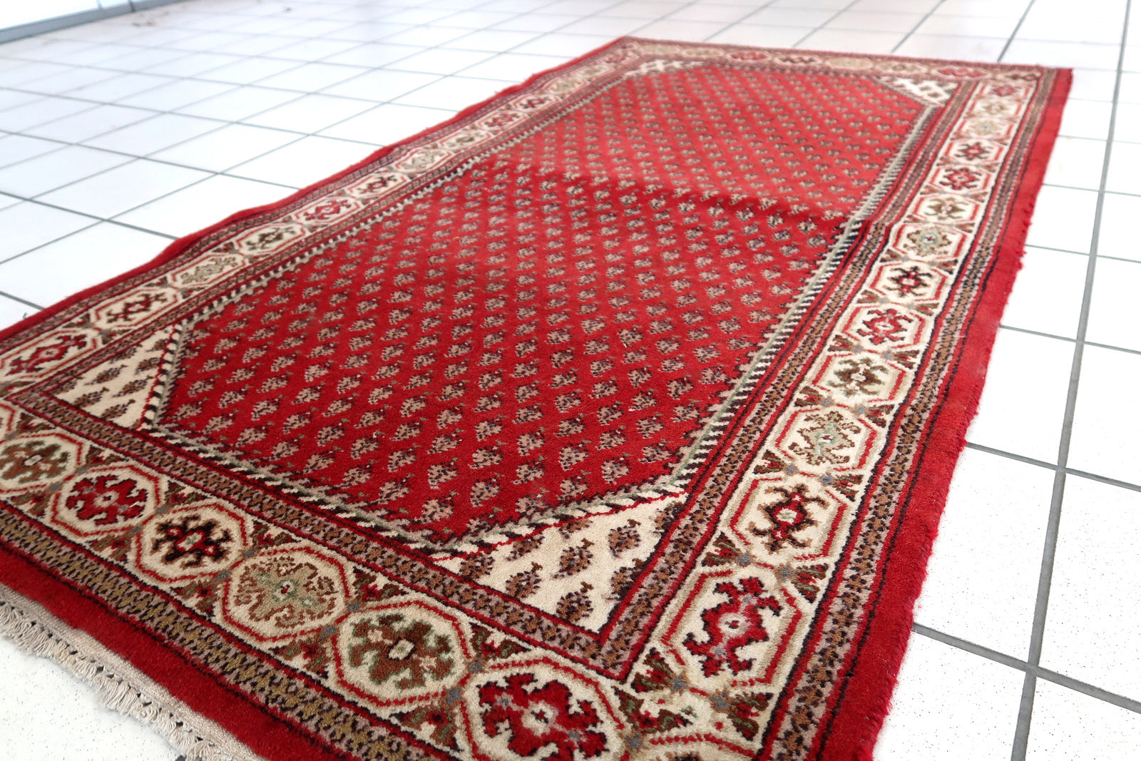 Handmade vintage Indian Seraband rug in red color and all-over design. The rug has been made in the end of 20th century. It is in original good condition.