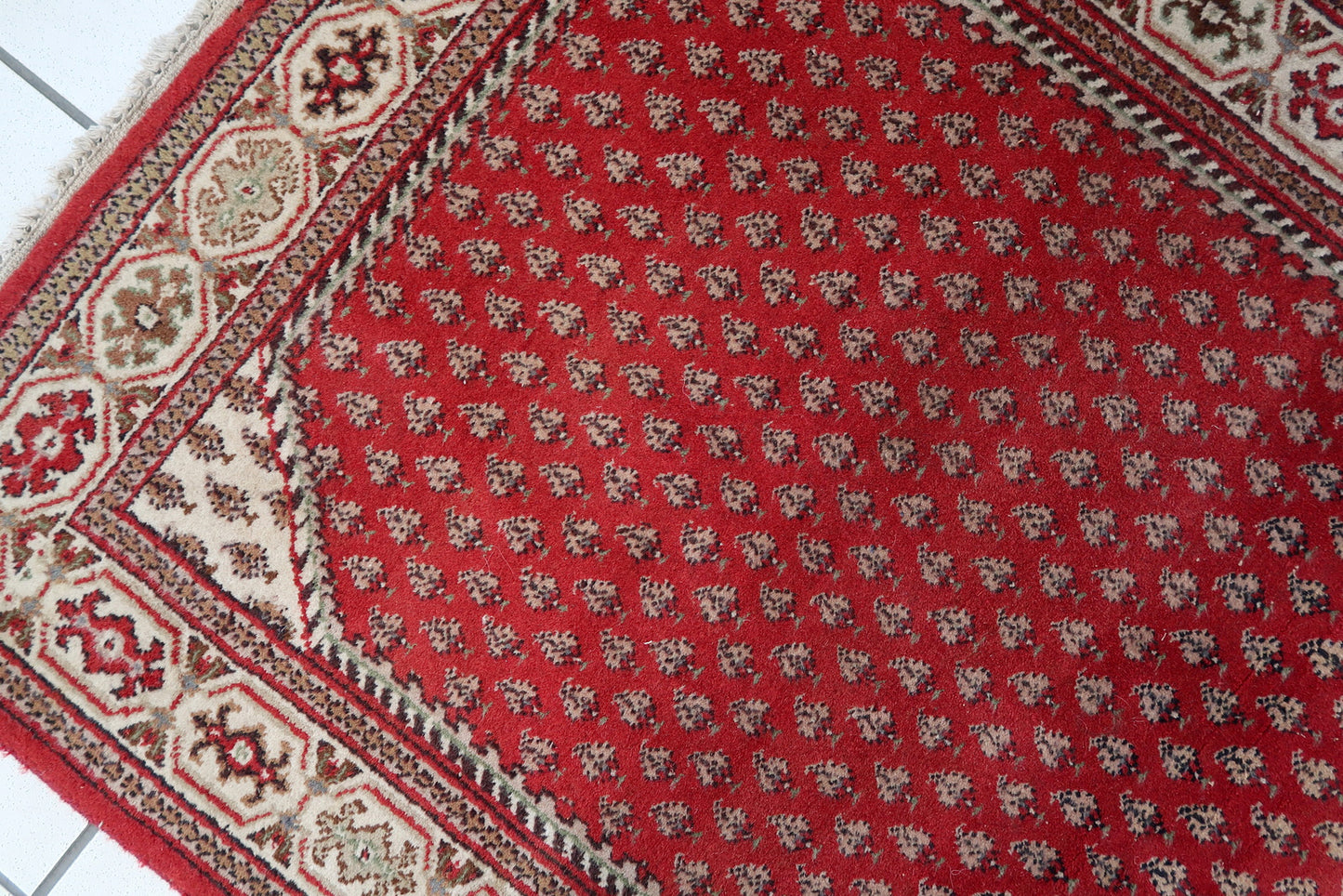 Handmade vintage Indian Seraband rug in red color and all-over design. The rug has been made in the end of 20th century. It is in original good condition.