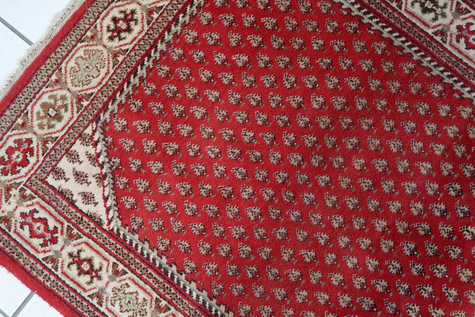 Handmade vintage Indian Seraband rug in red color and all-over design. The rug has been made in the end of 20th century. It is in original good condition.
