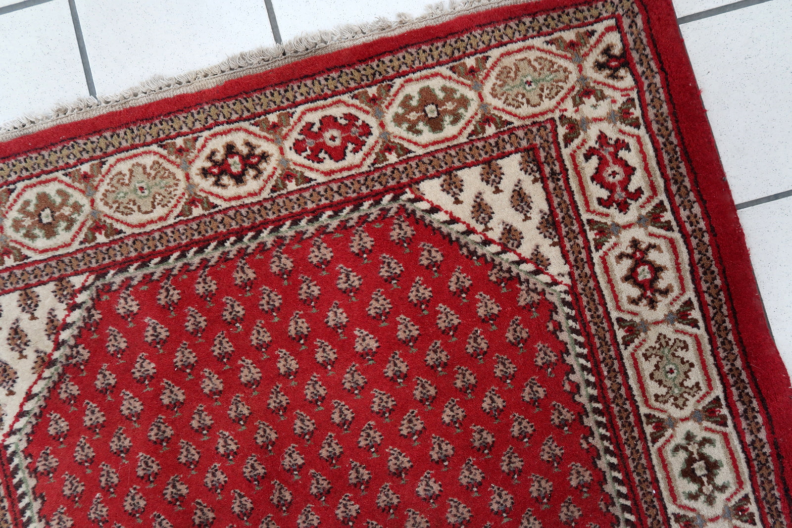 Handmade vintage Indian Seraband rug in red color and all-over design. The rug has been made in the end of 20th century. It is in original good condition.