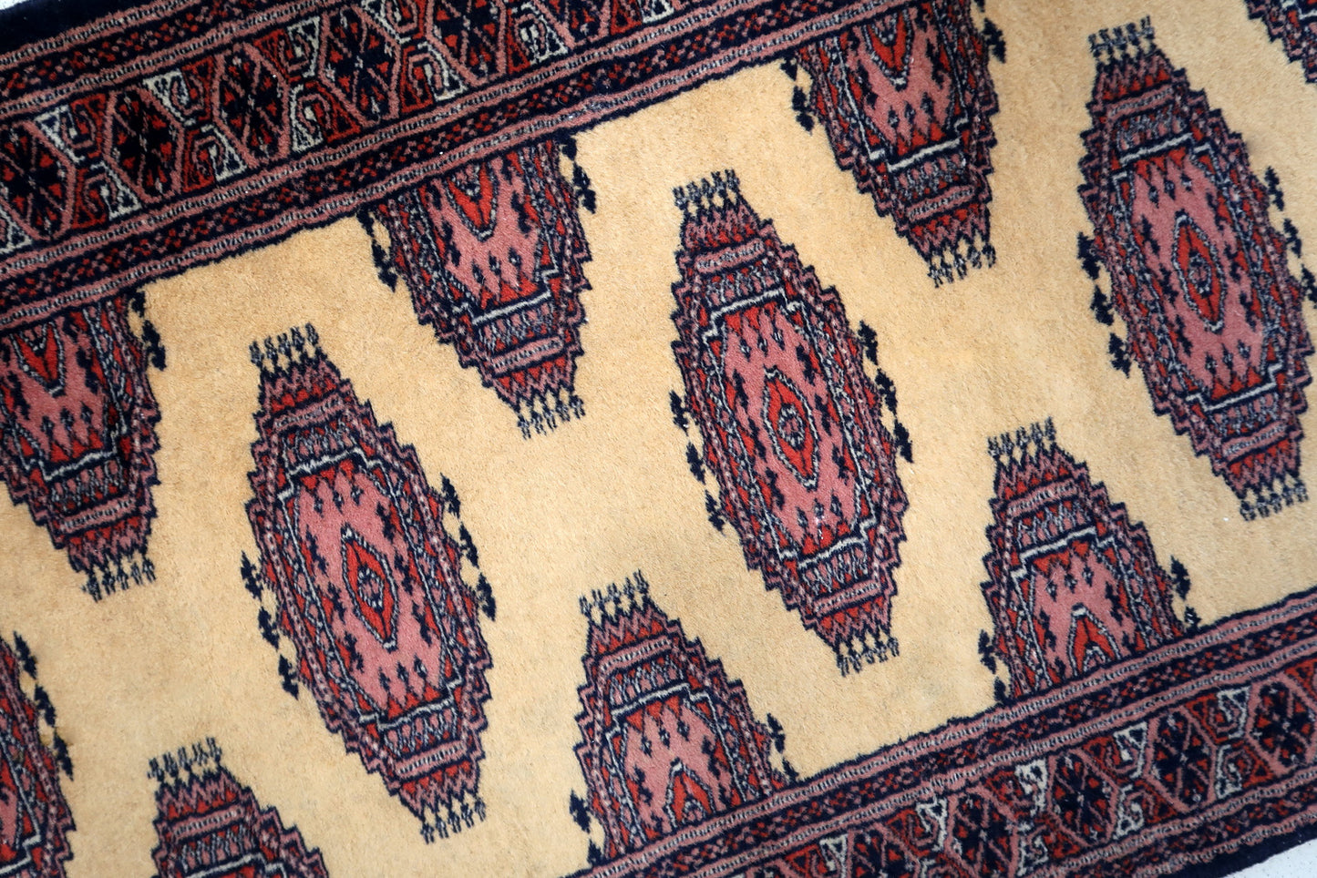 Handmade vintage Uzbek Bukhara narrow runner in yellow wool. The rug has traditional design. It is from the end of 20th century, in original good condition.