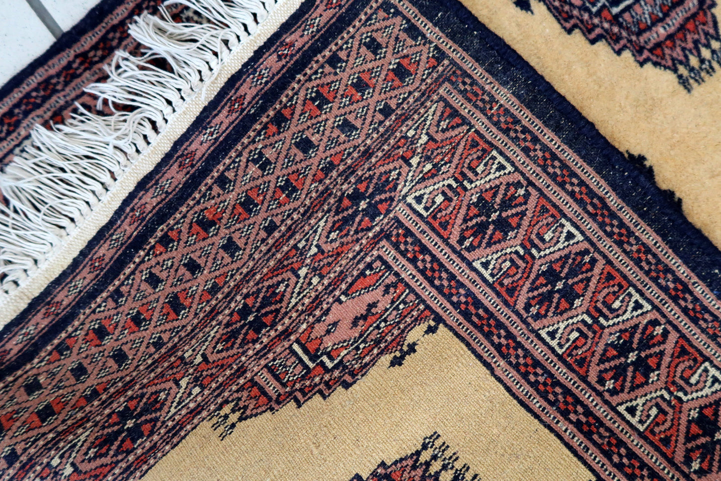 Handmade vintage Uzbek Bukhara narrow runner in yellow wool. The rug has traditional design. It is from the end of 20th century, in original good condition.