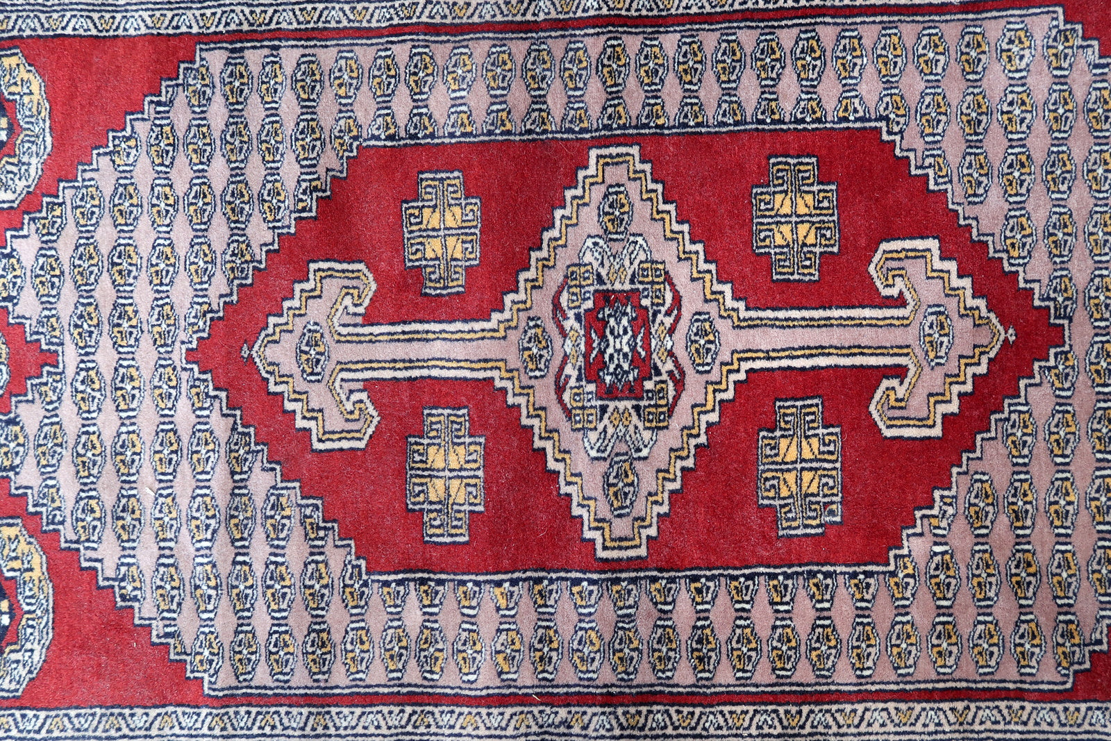 Handmade vintage Uzbek Bukhara rug in unusual design. The rug is from the end of 20th century. It is in original good condition.