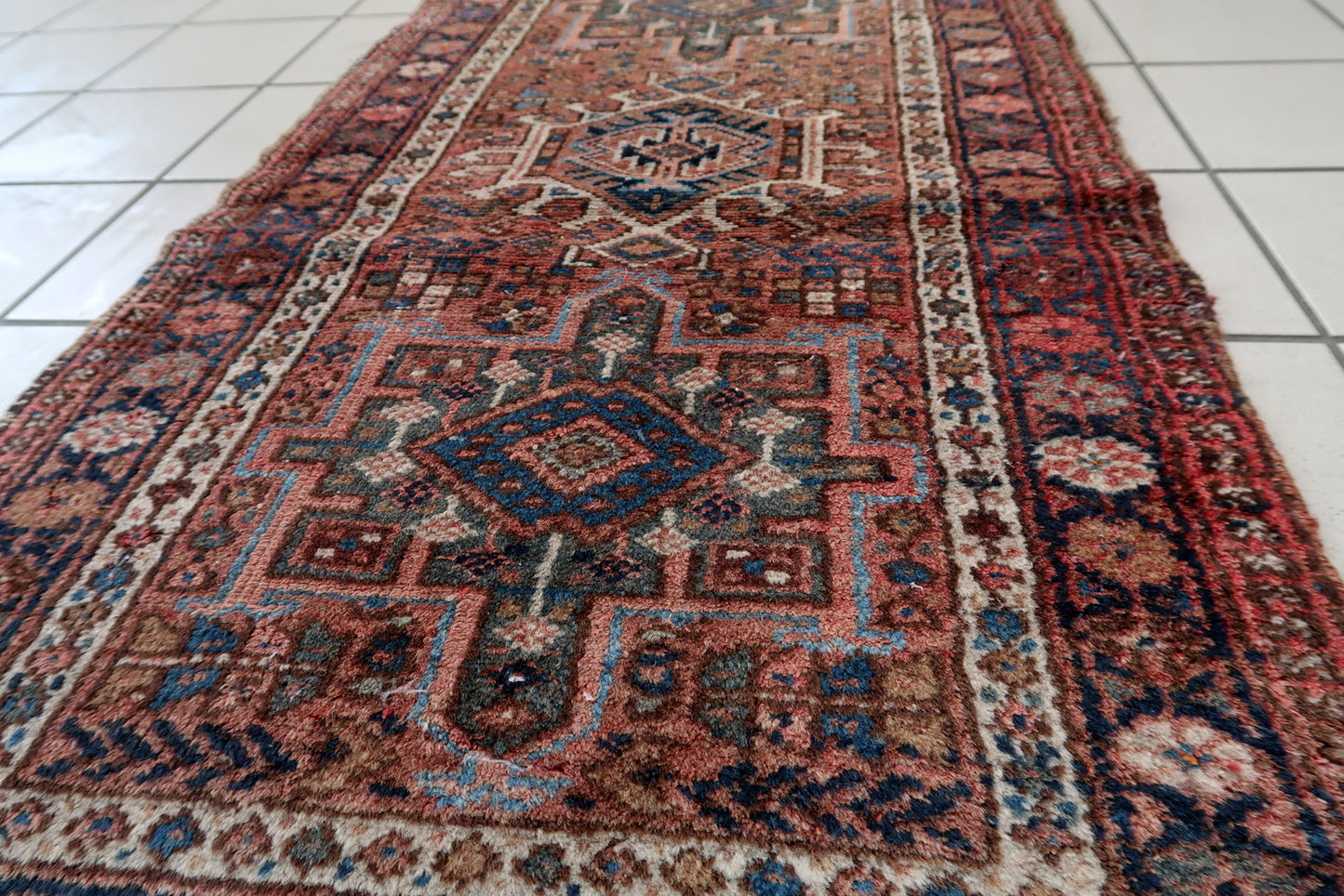 Handmade vintage Karajeh rug in traditional triple medallion design. The rug is in pale red color. It is from the end of 20th century in original good condition.