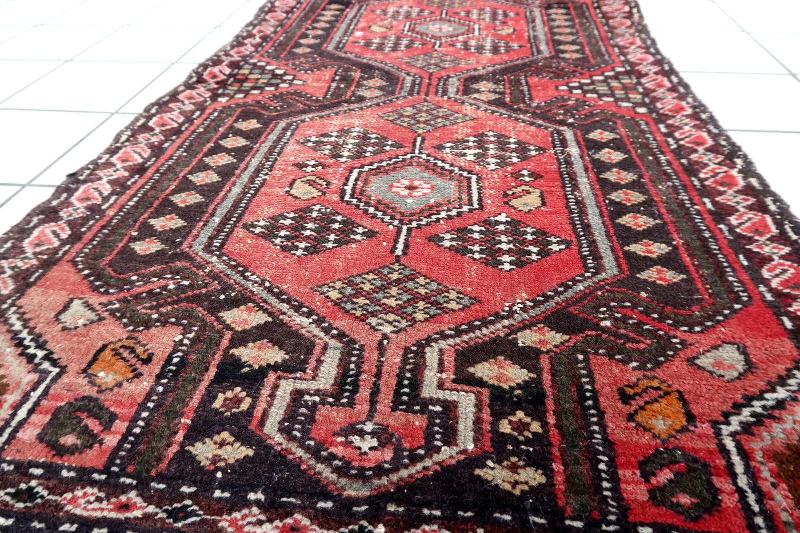 Handmade vintage Persian Hamadan rug in pale red and brown colors. The rug is from the middle of 20th century in original condition, it has some signs of age.