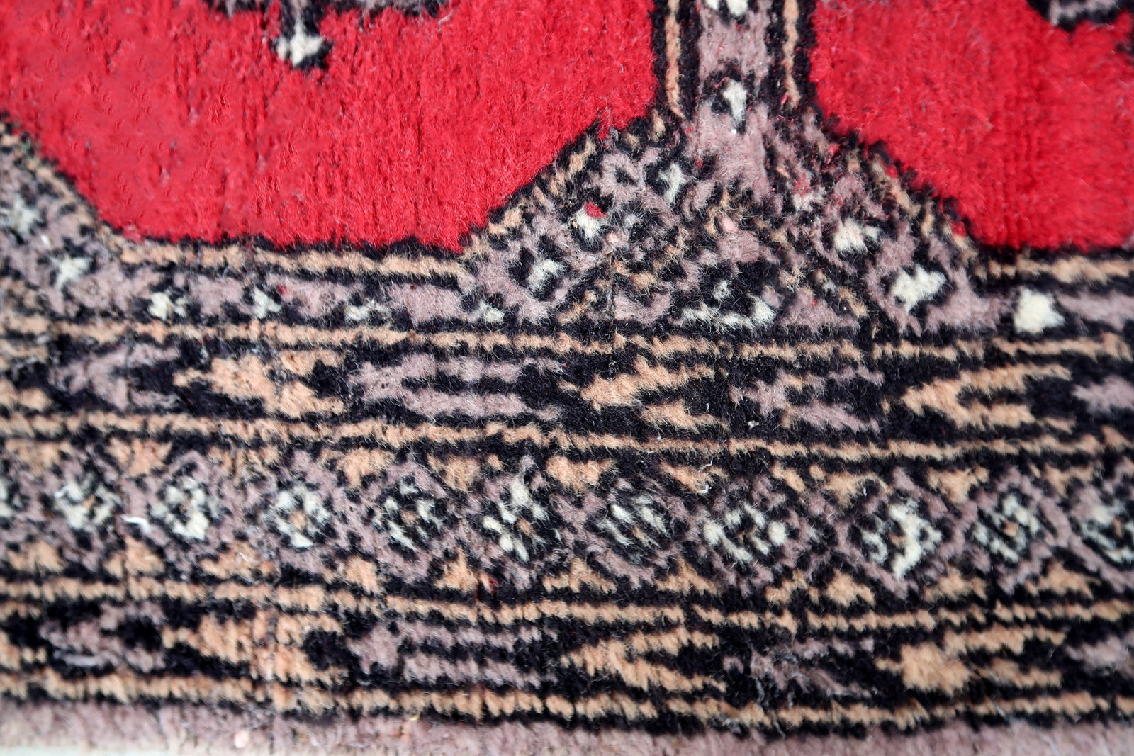 Handmade vintage Uzbek Bukhara rug in traditional design. The rug is from the end of 20th century, it is in original condition, has some signs of age.